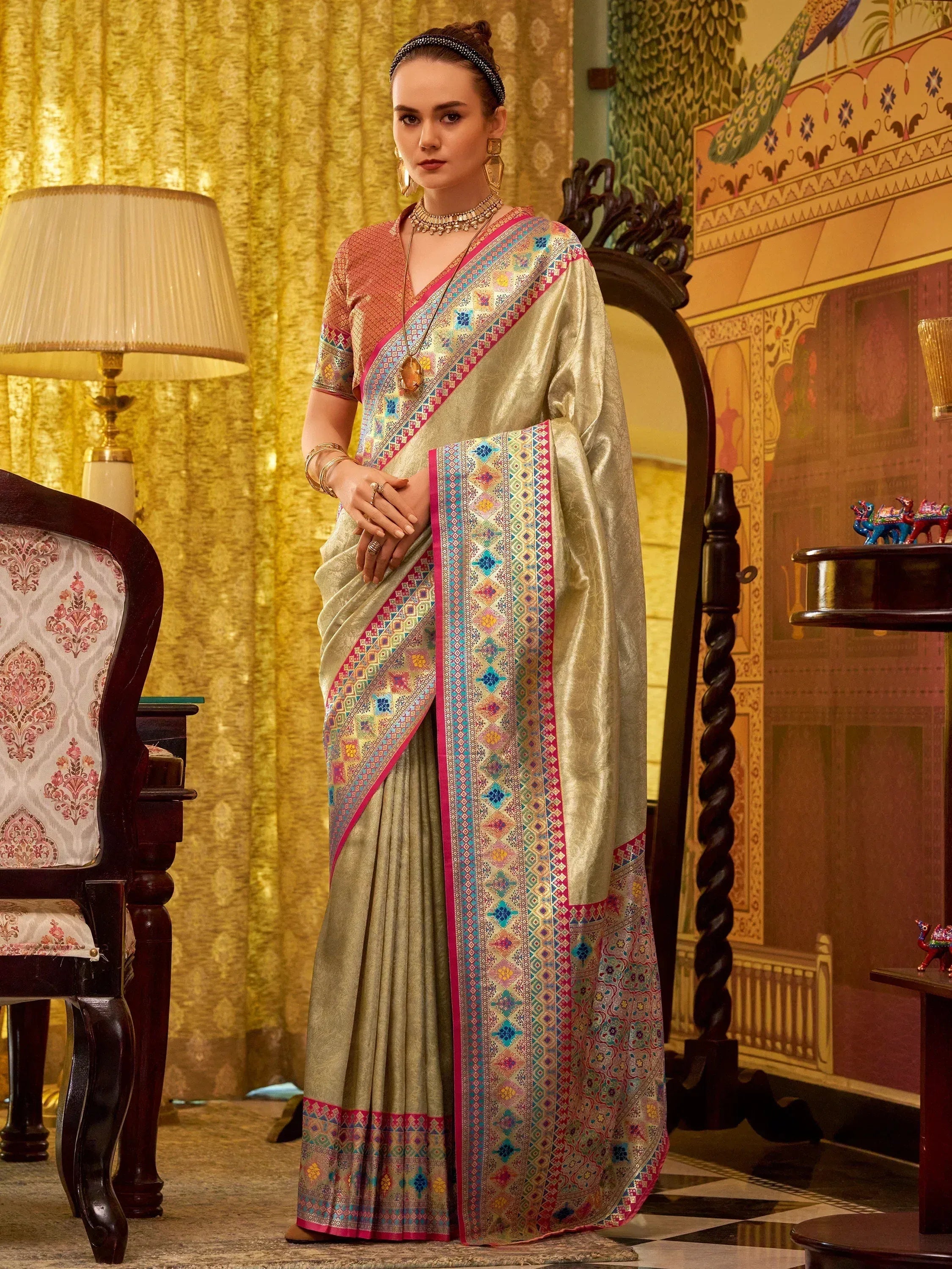 Elegant Indian saree with colorful geometric border, paired with designer blouse for festive occasions