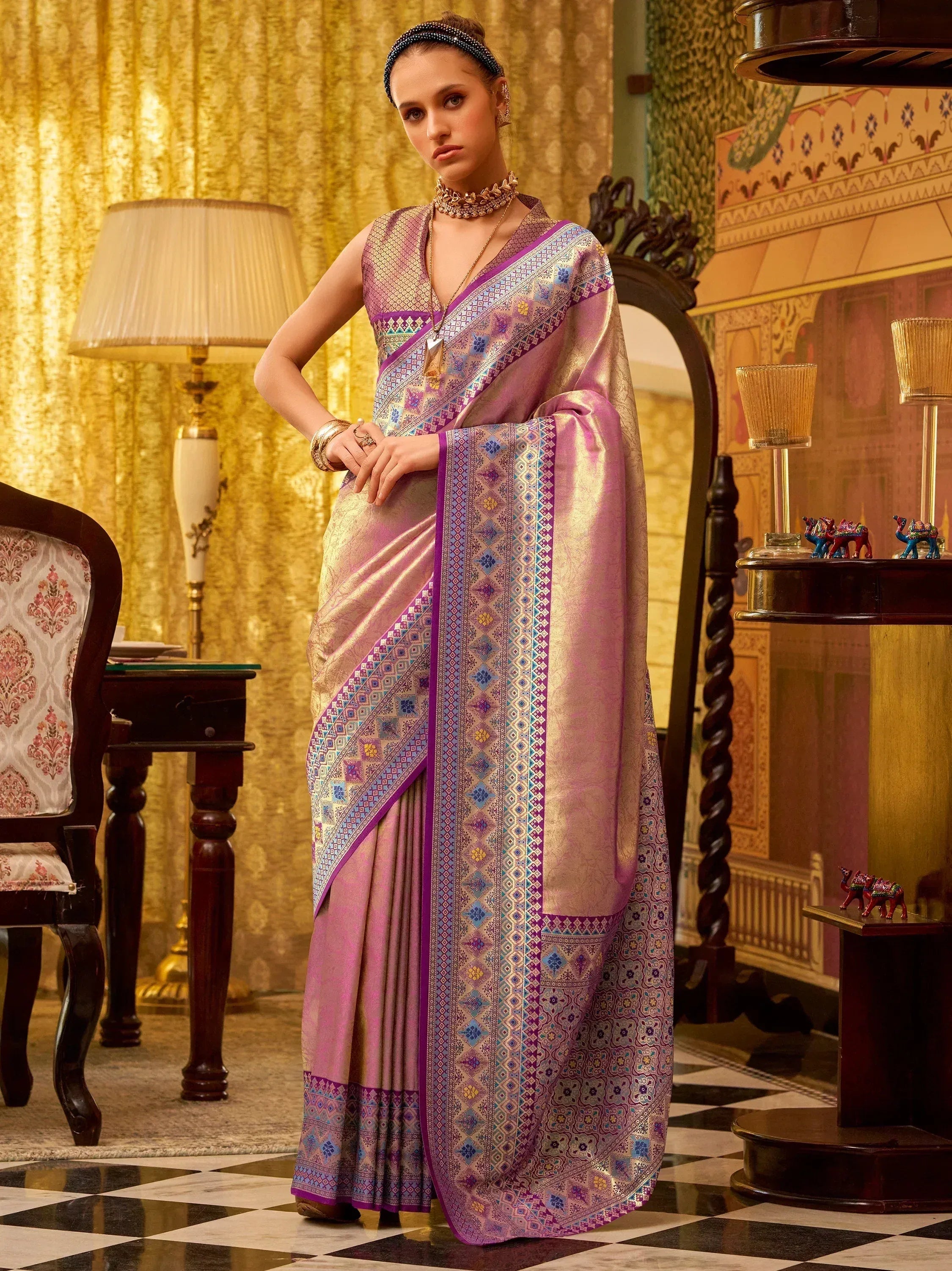 Elegant purple designer saree with intricate geometric patterns and golden accents, perfect for ethnic occasions.