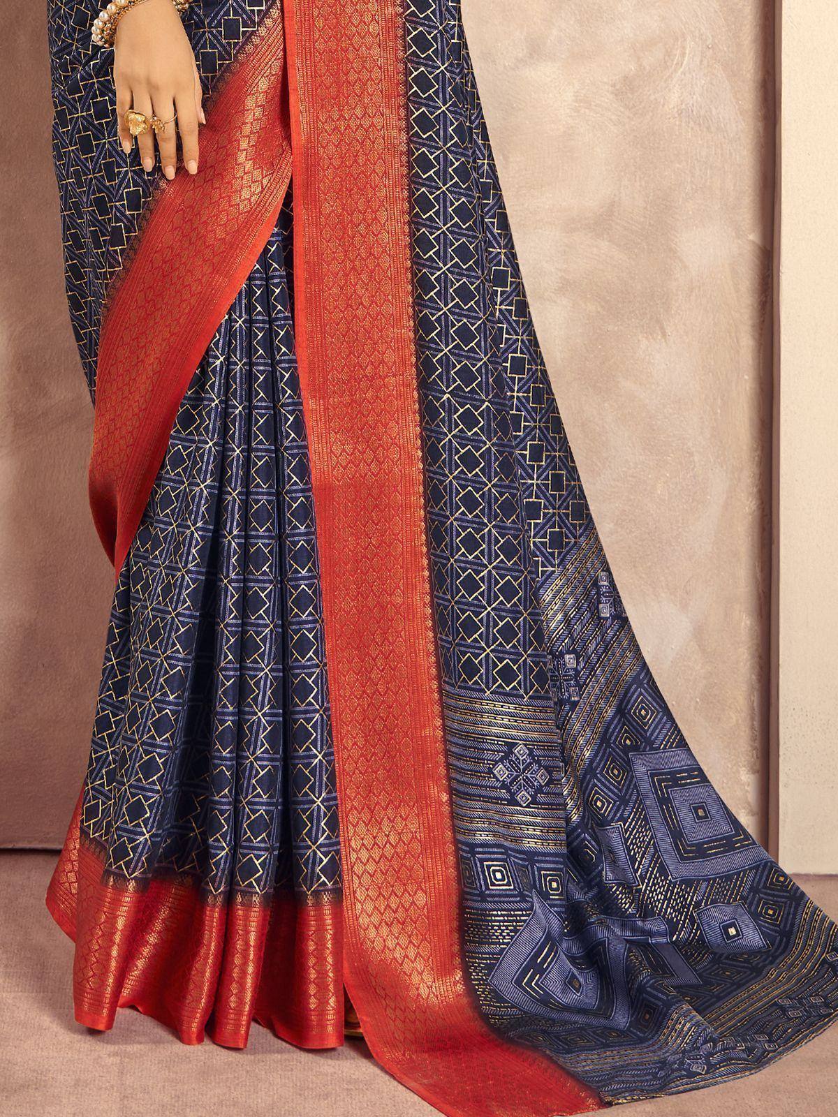 Navy blue and orange designer saree with geometric gold patterns, perfect for ethnic wear occasions.