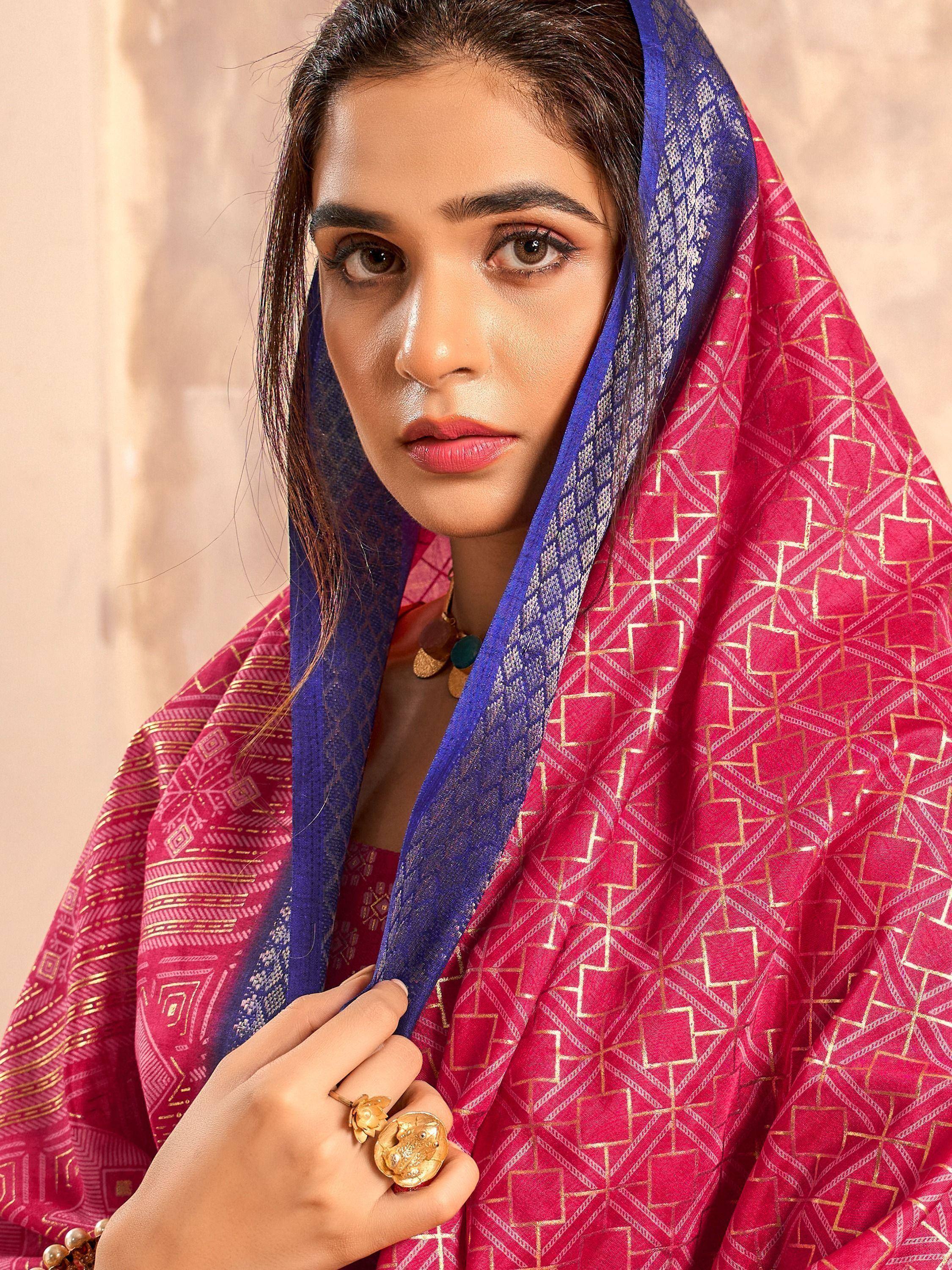 Woman in pink and blue ethnic saree with gold geometric print, traditional Indian wear