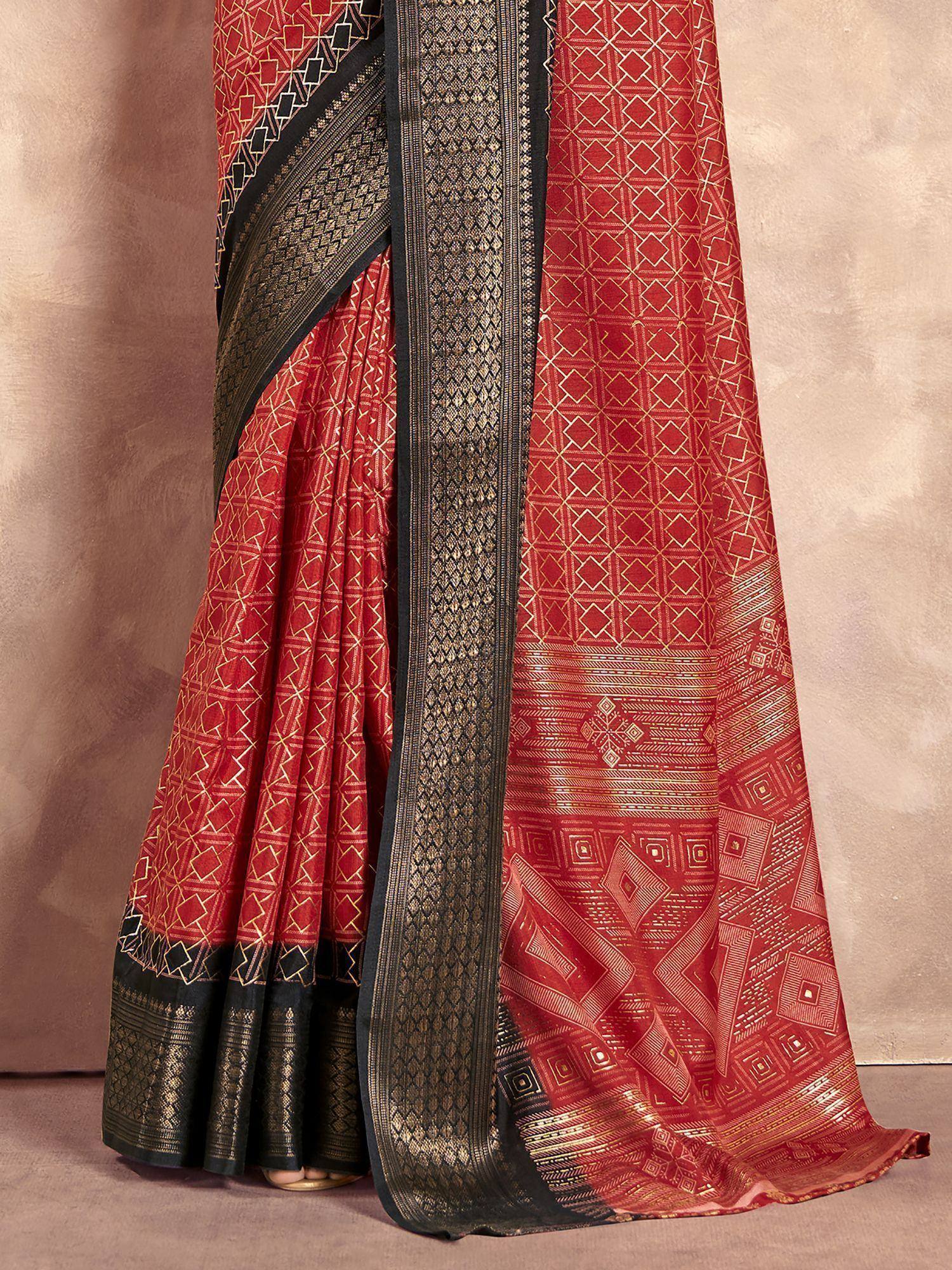 Red and black ethnic saree with geometric gold patterns and woven border, perfect for Indian occasions.