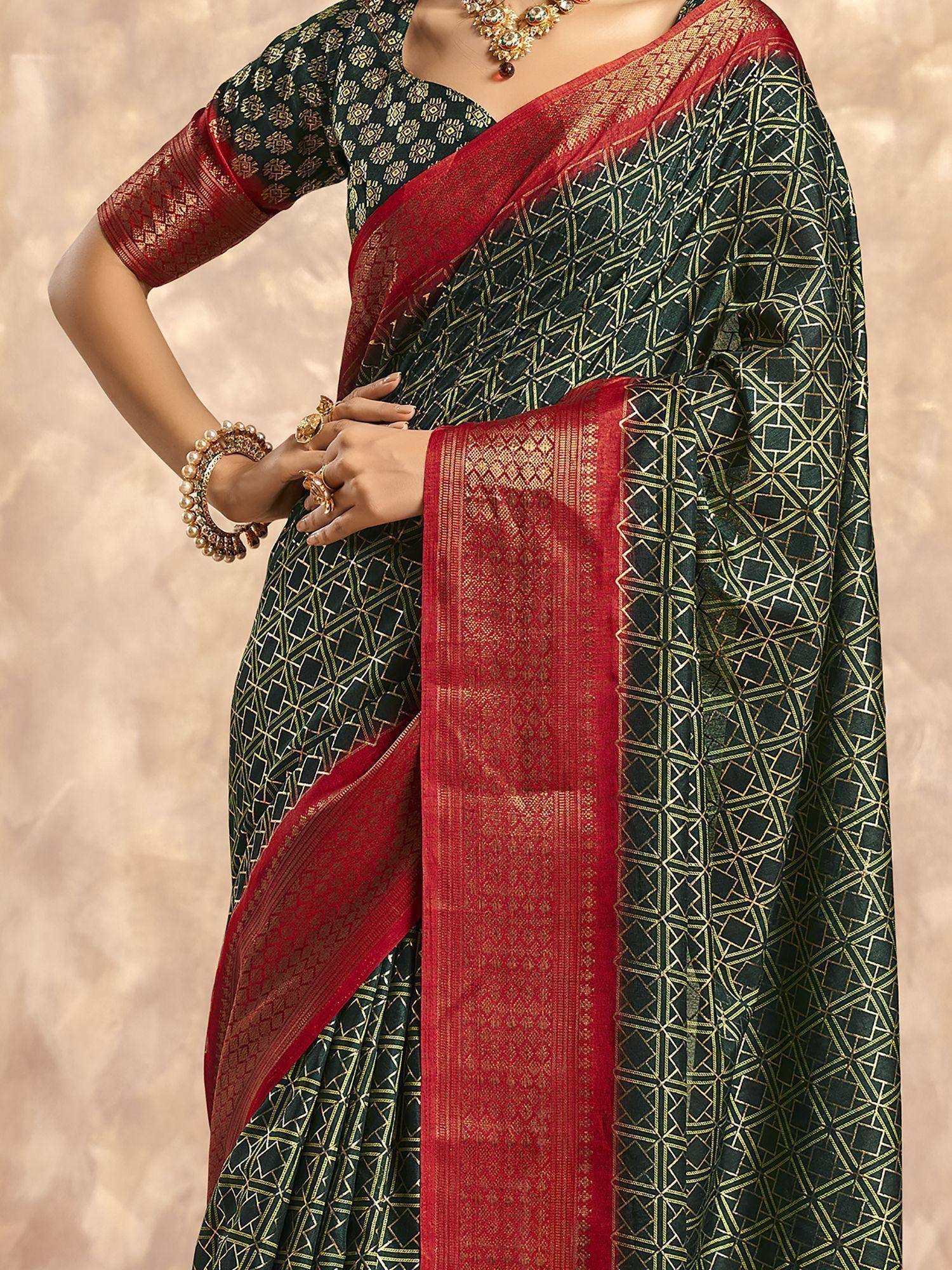 Elegant black and red saree with gold geometric print and intricate border, paired with matching blouse and jewelry