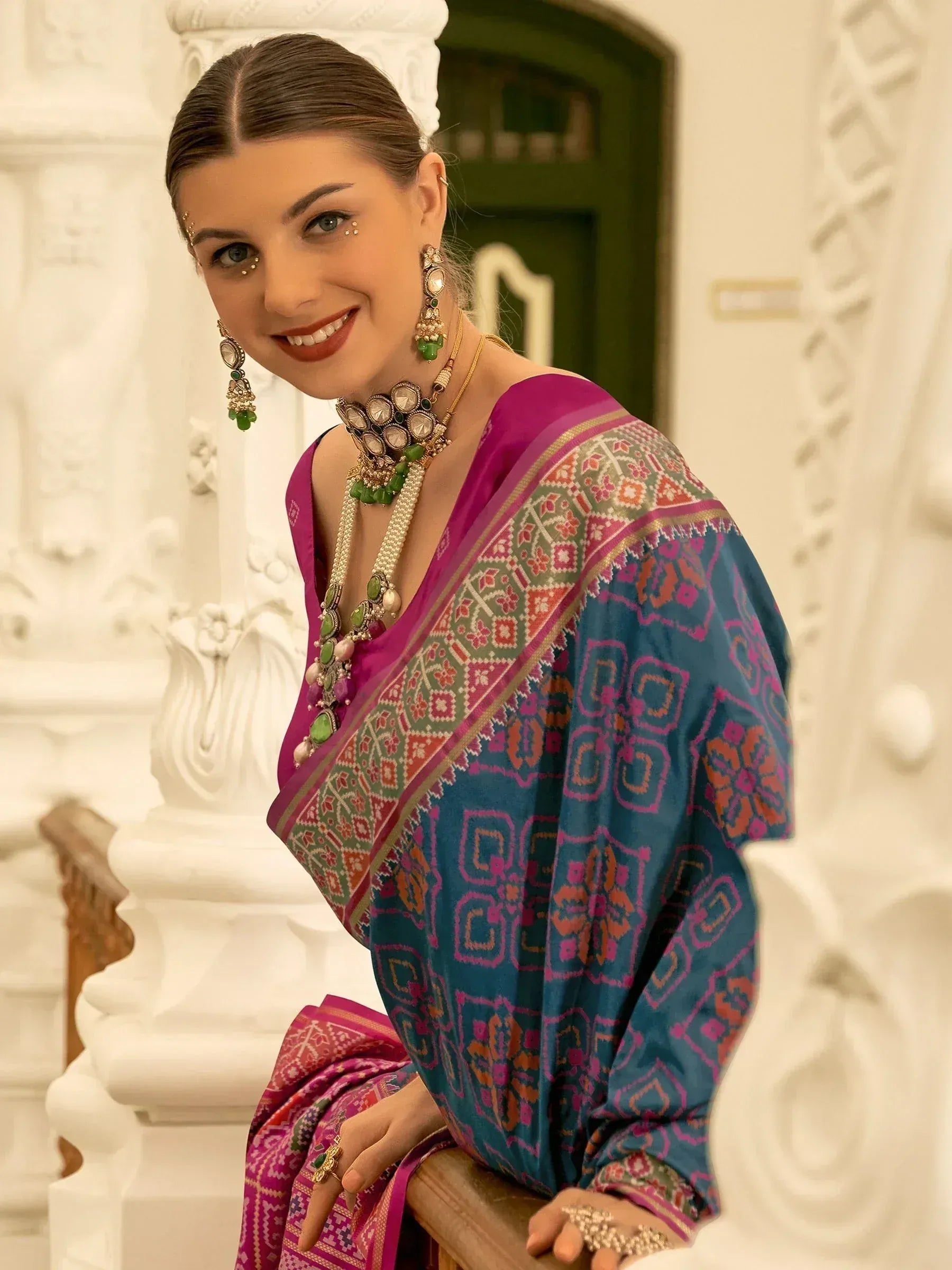 Woman in vibrant Indian saree with intricate patterns and traditional jewelry, perfect for ethnic occasions