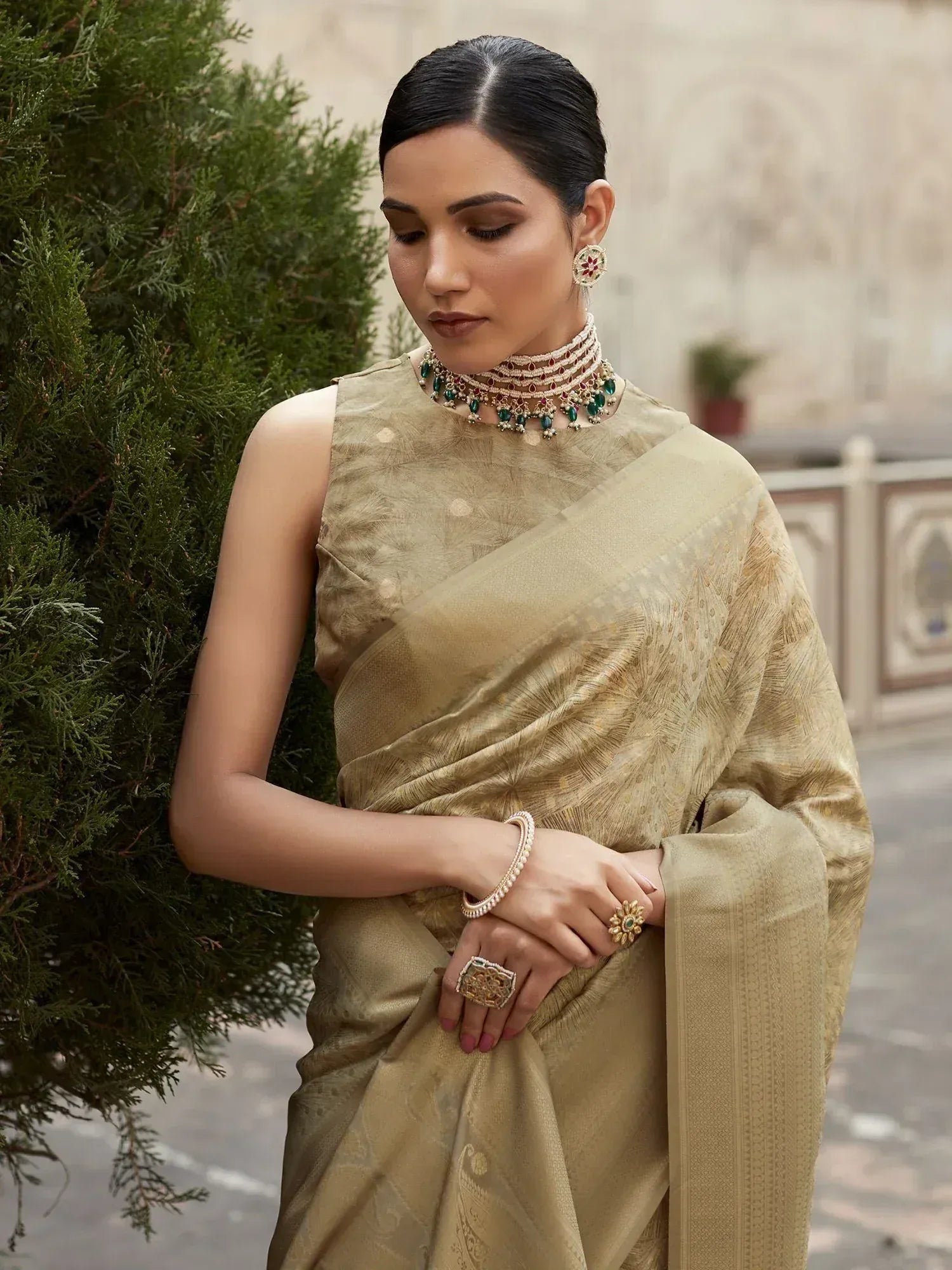 Elegant woman in gold designer saree with intricate jewelry, perfect for Indian ethnic wear occasions.