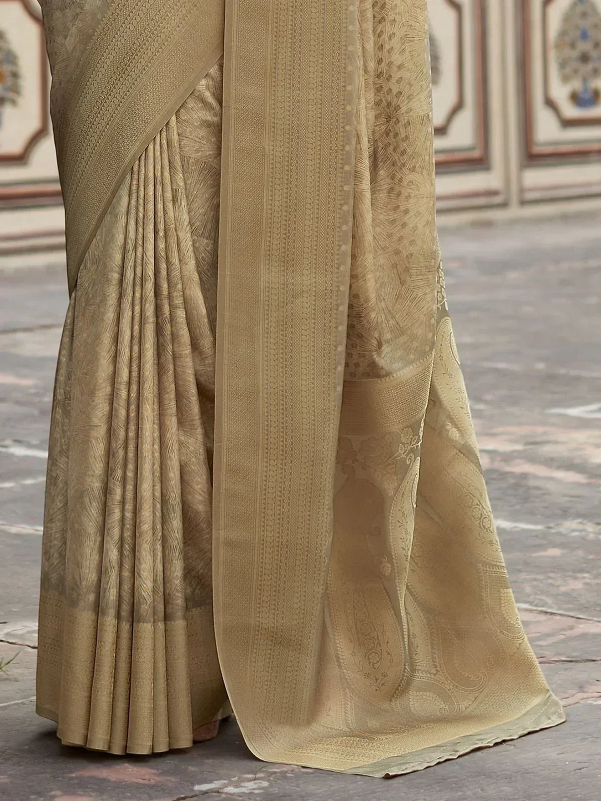 Beige designer saree with intricate paisley and border patterns, ethnic Indian wear