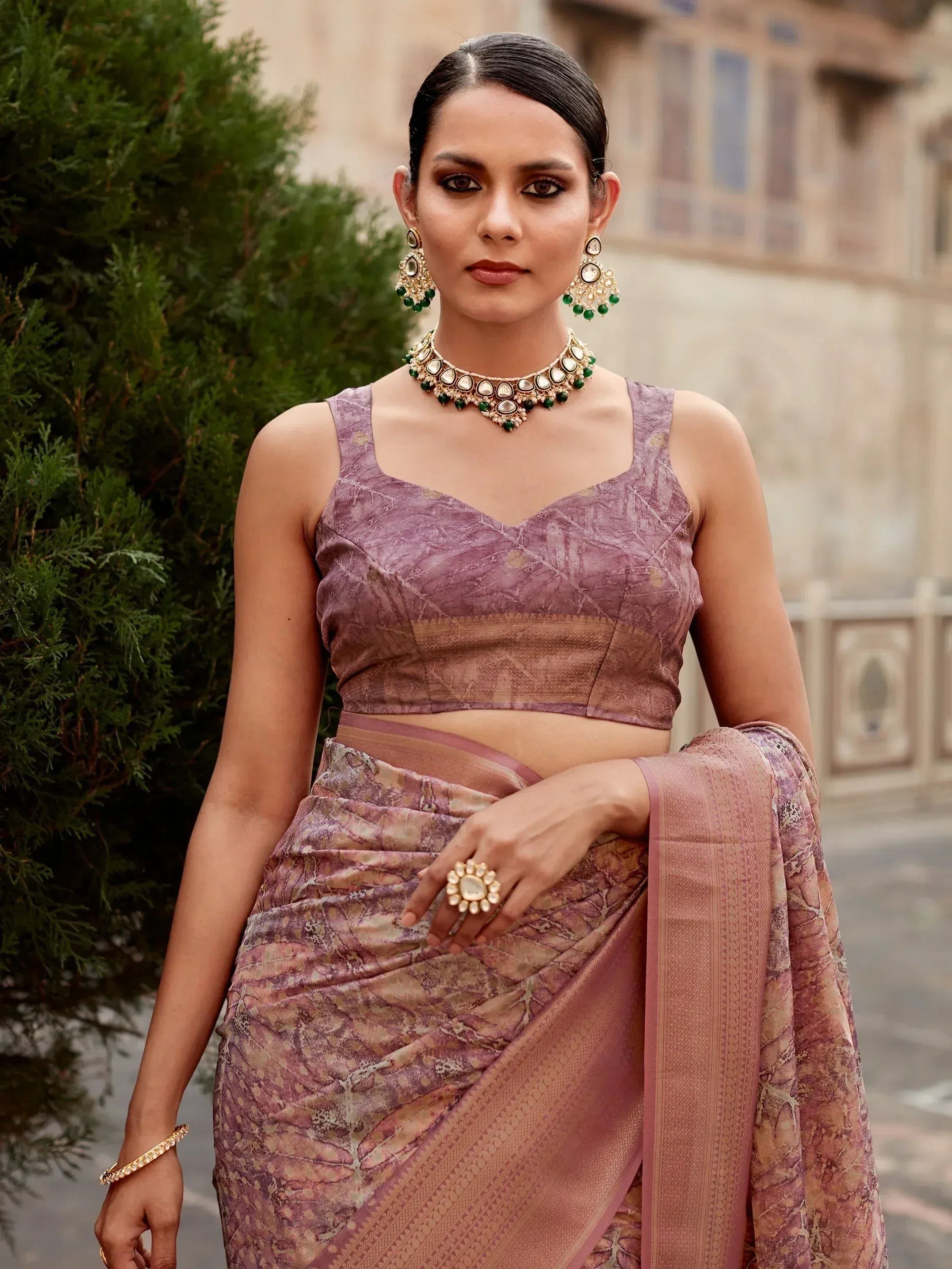Woman in elegant purple designer saree with gold jewelry, perfect for Indian ethnic occasions