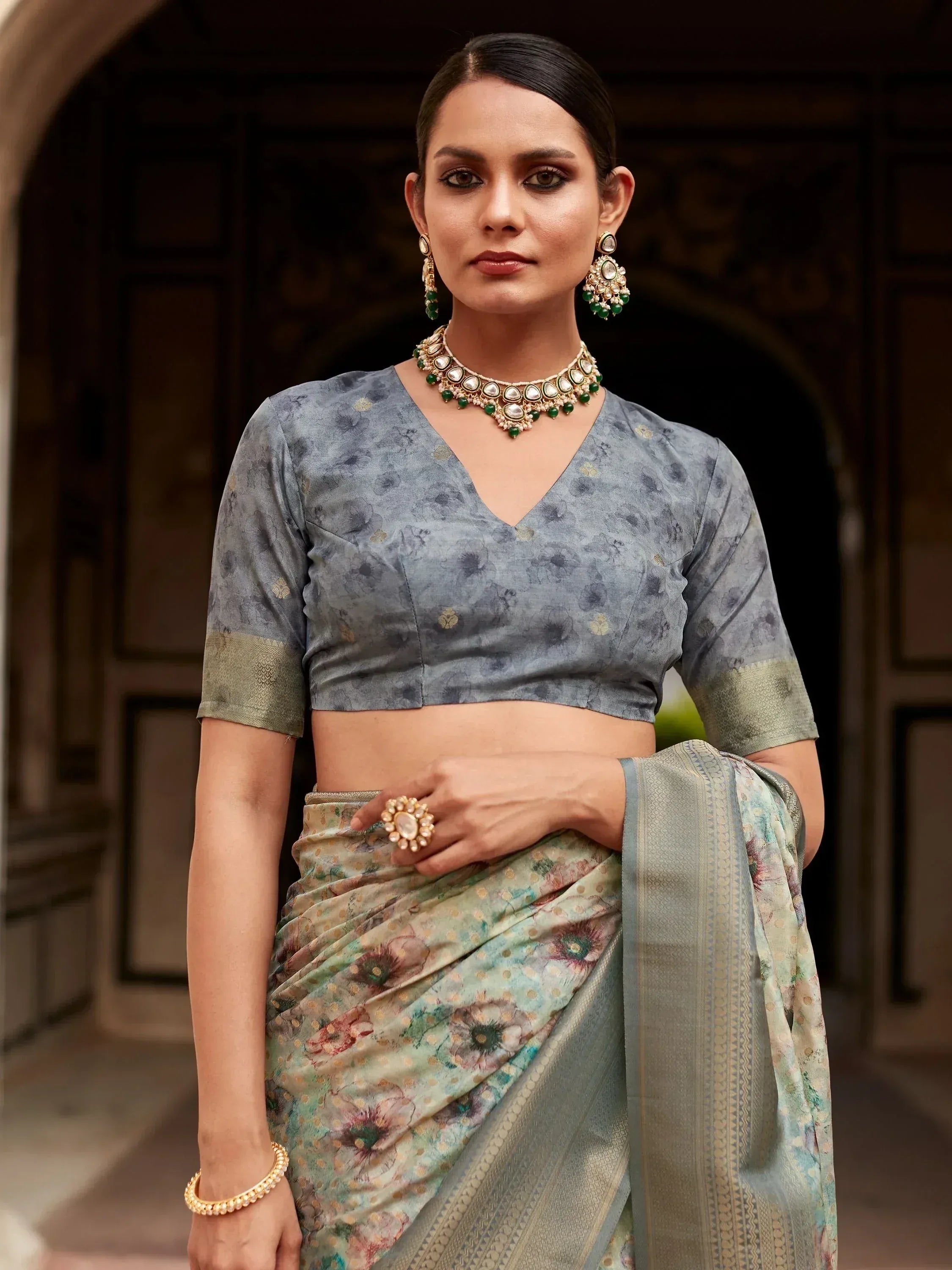 Woman in floral print saree with matching blouse and traditional jewelry, Indian ethnic wear