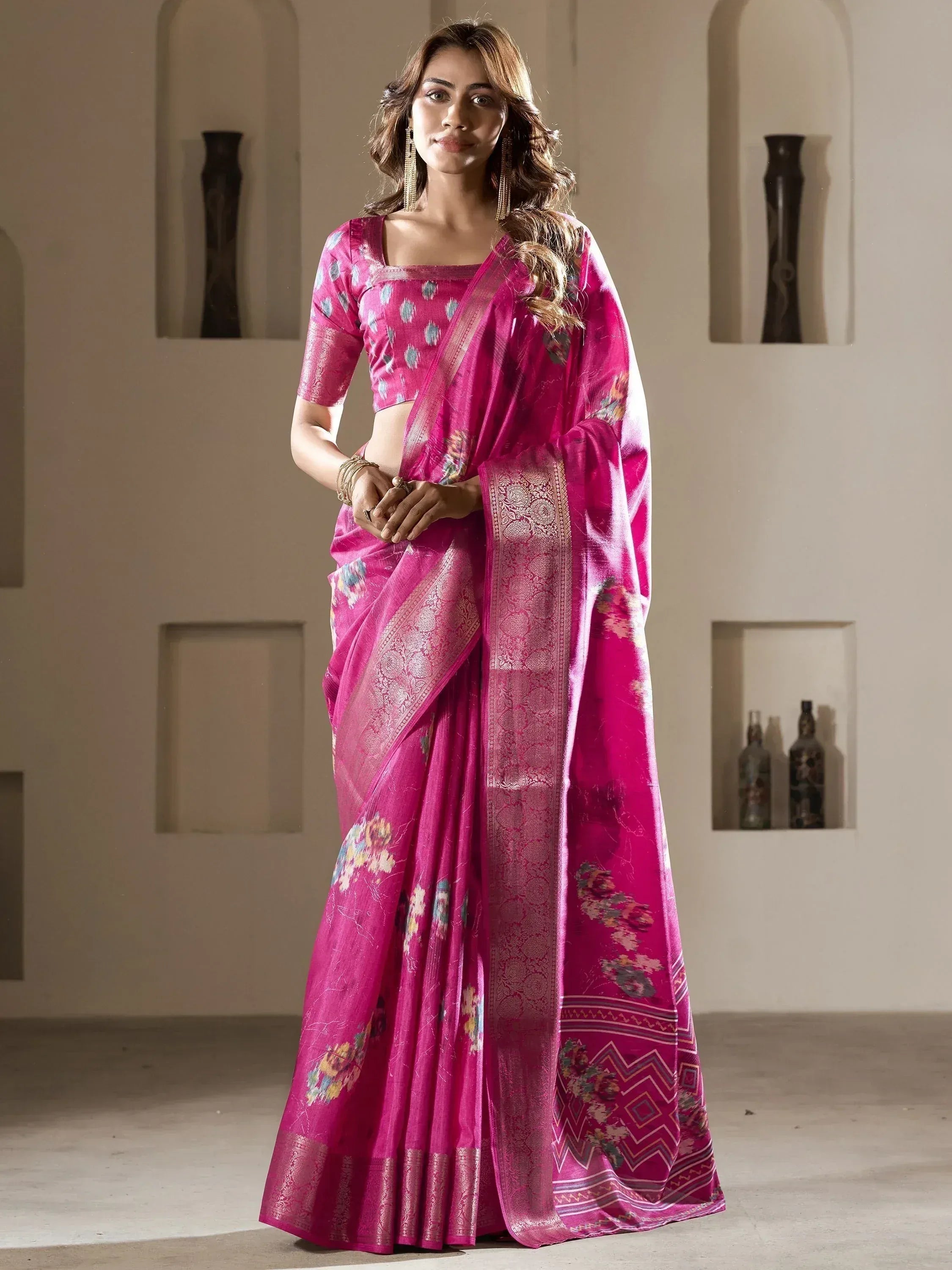 Vibrant pink floral saree with gold border, perfect for Indian ethnic wear and festive occasions.