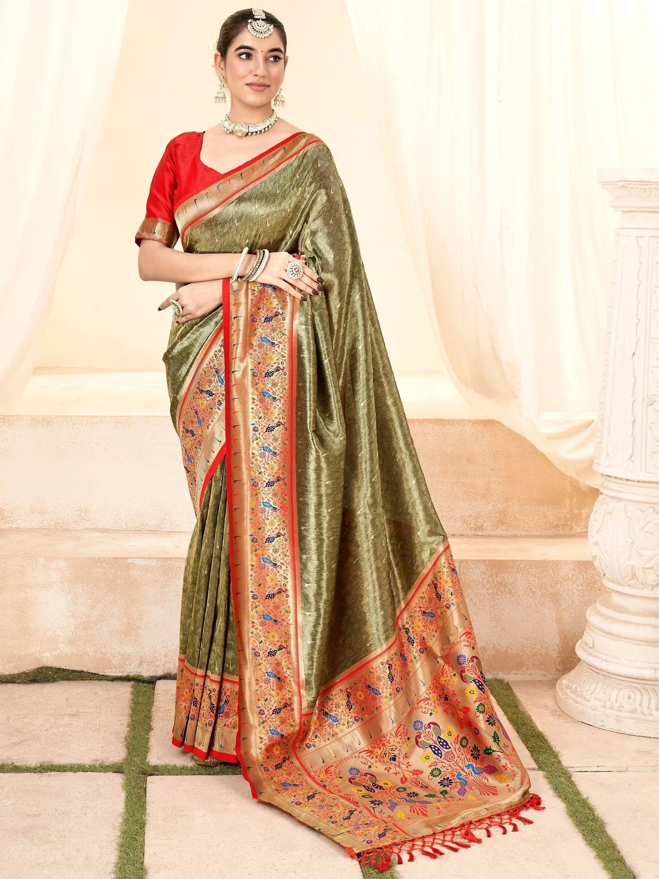 Olive green silk saree with peacock embroidery and red blouse, perfect for Indian ethnic wear occasions.