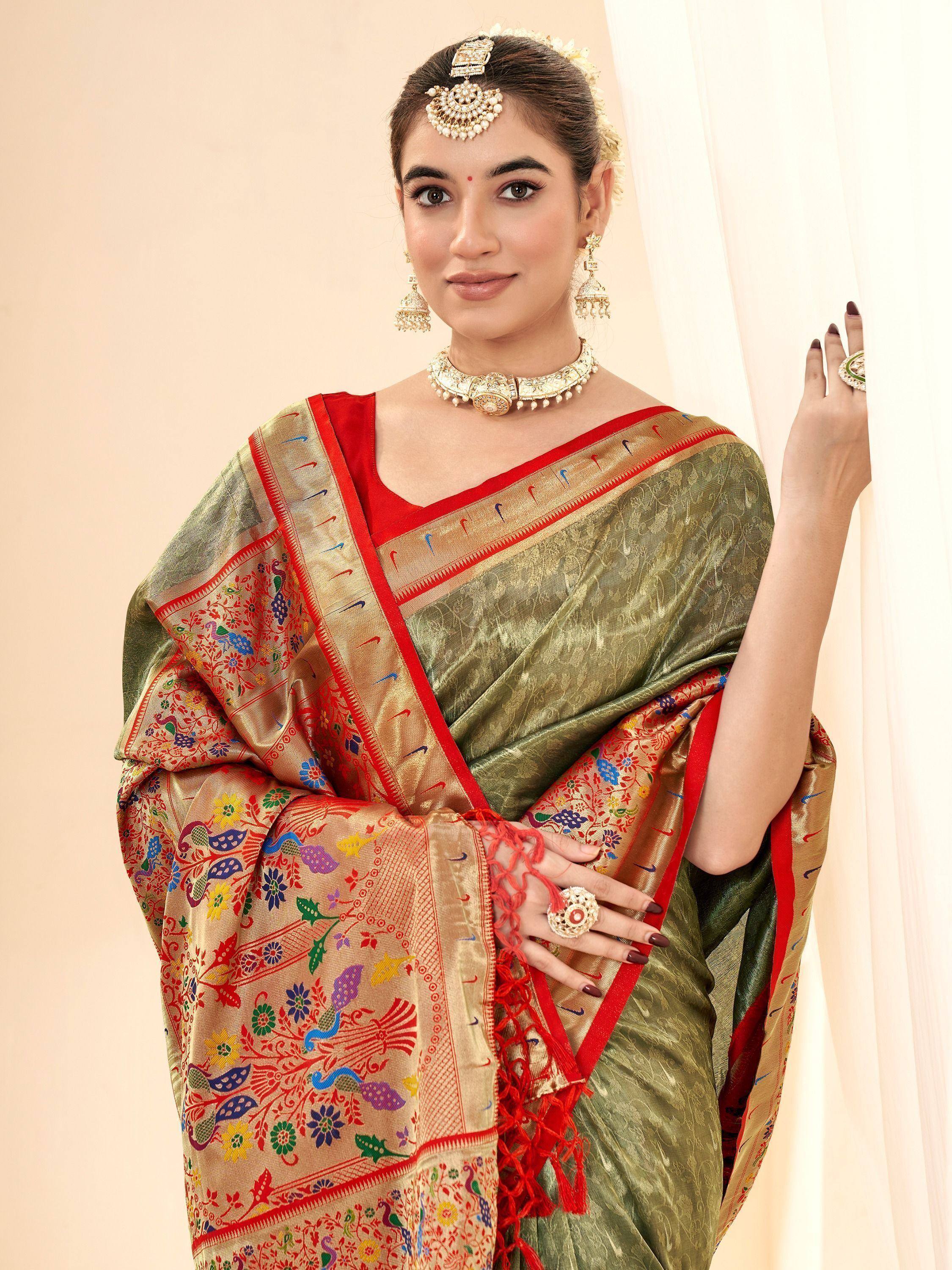 Woman in olive green and red embroidered saree with peacock motifs, traditional Indian ethnic wear