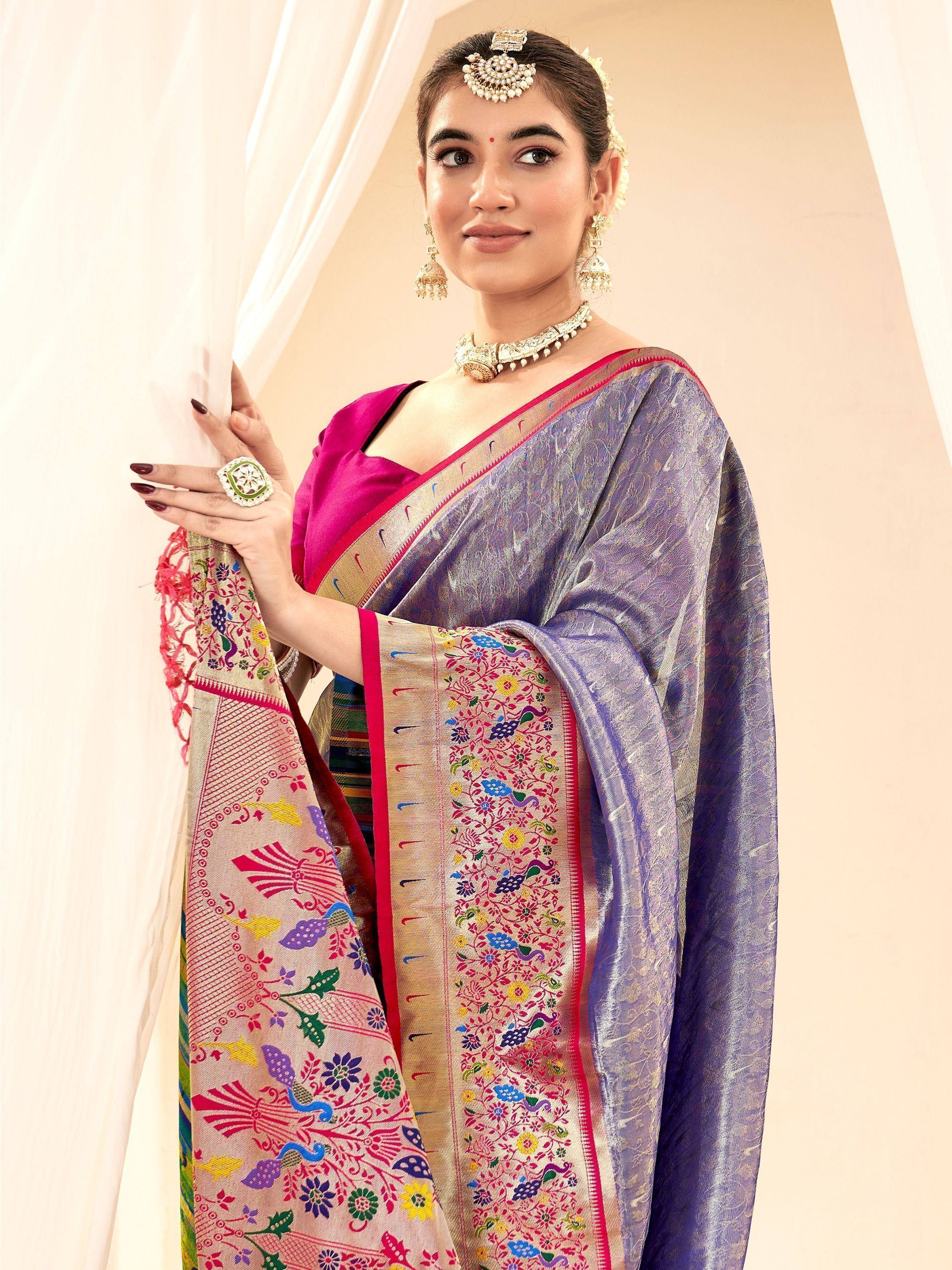 Woman in purple and pink embroidered saree with floral peacock design, traditional Indian ethnic wear
