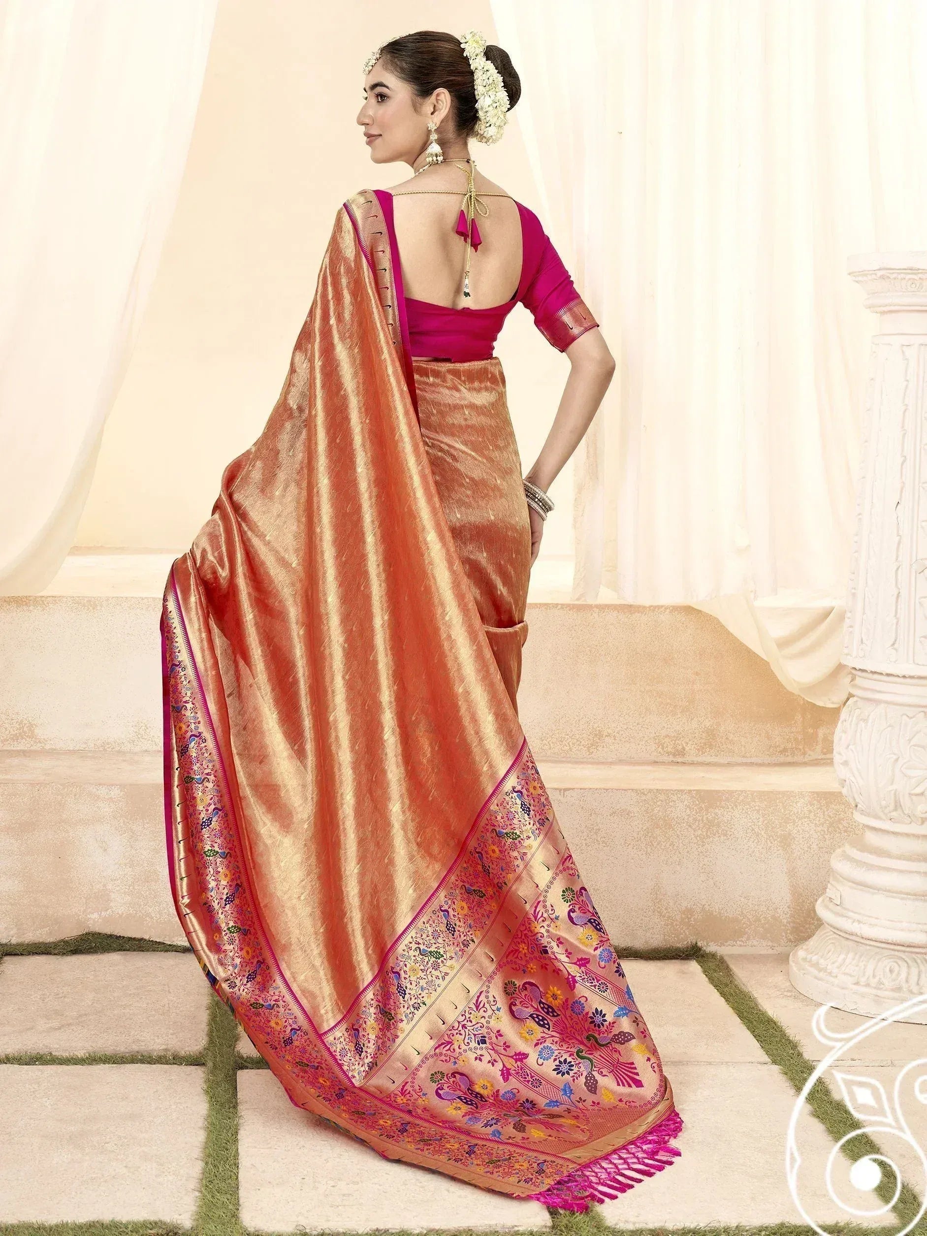 Woman in elegant peach silk saree with peacock embroidery and magenta blouse, perfect for Indian ethnic occasions