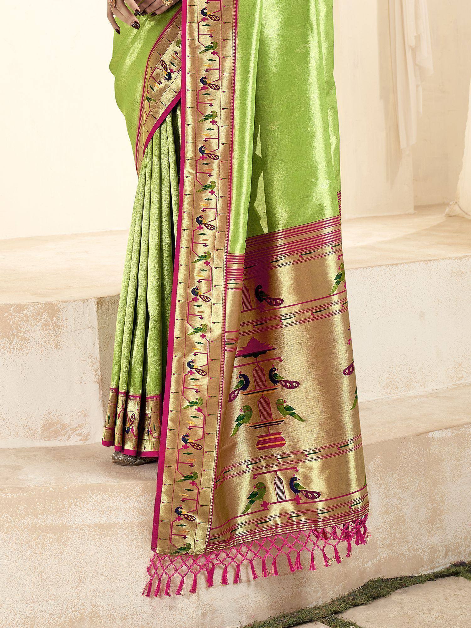 Lime green saree with gold border, bird motifs, and pink tassels, styled for ethnic wear