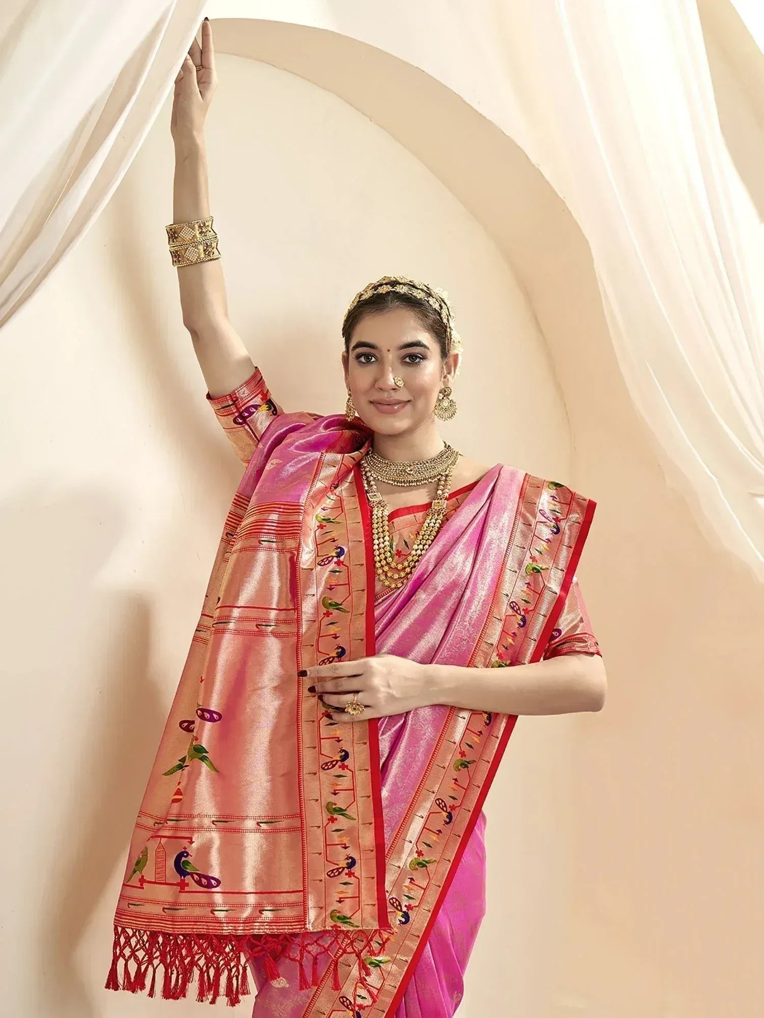 Pink embroidered saree with peacock motifs, traditional Indian ethnic wear, gold jewelry, festive look