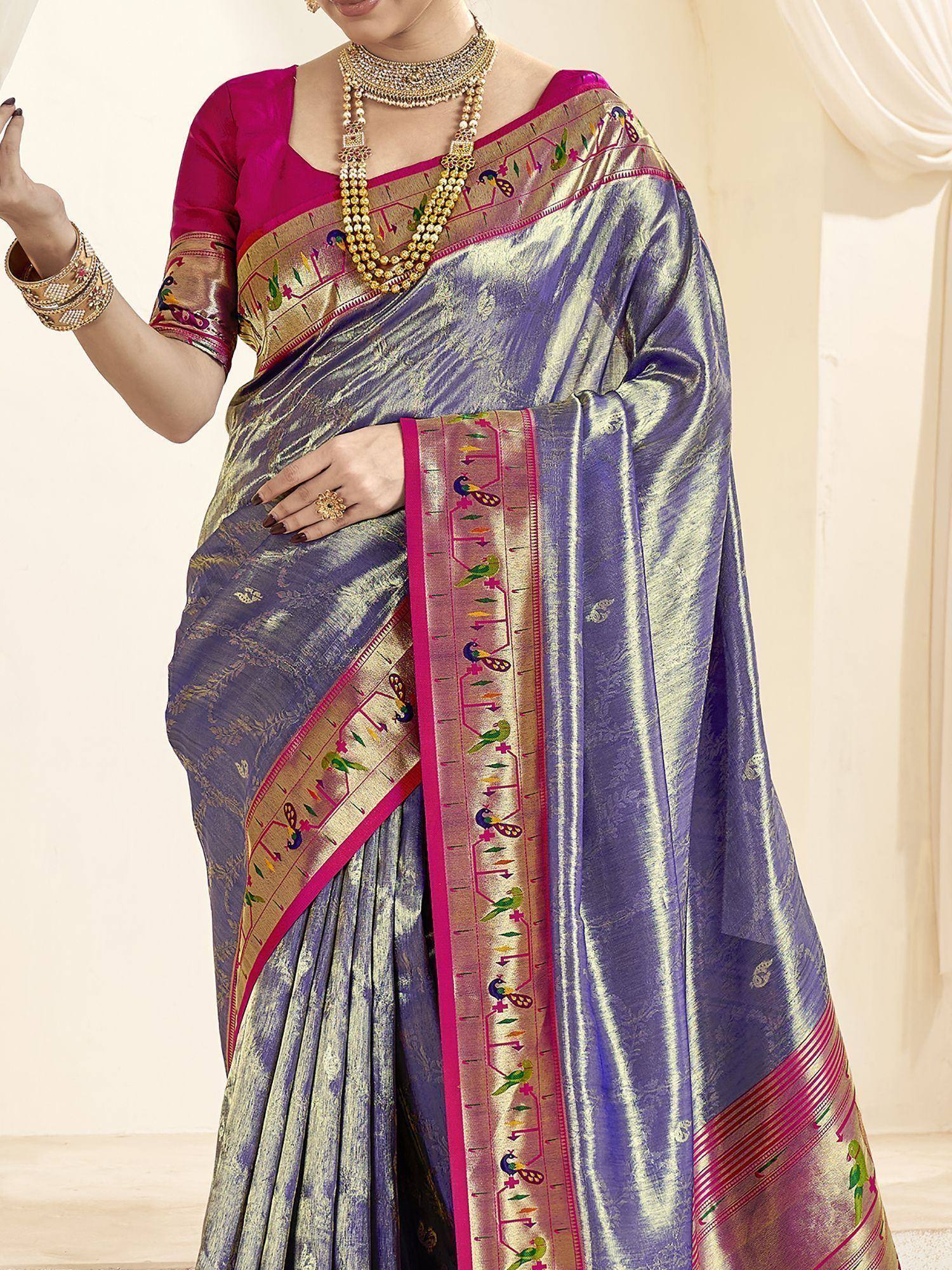 Purple and gold embroidered saree with peacock motifs, paired with pink blouse and traditional jewelry
