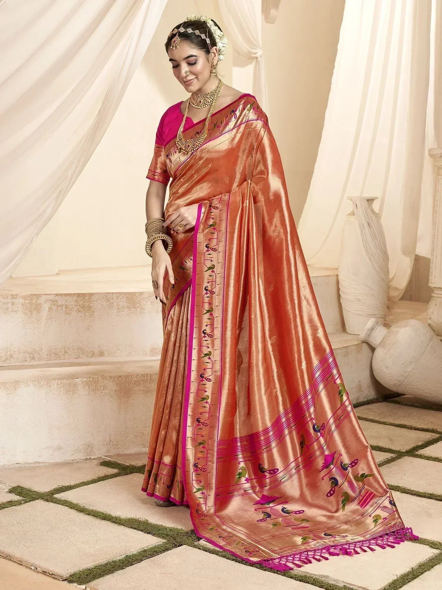 Elegant peach silk saree with pink border and bird motifs, paired with matching blouse for Indian ethnic wear