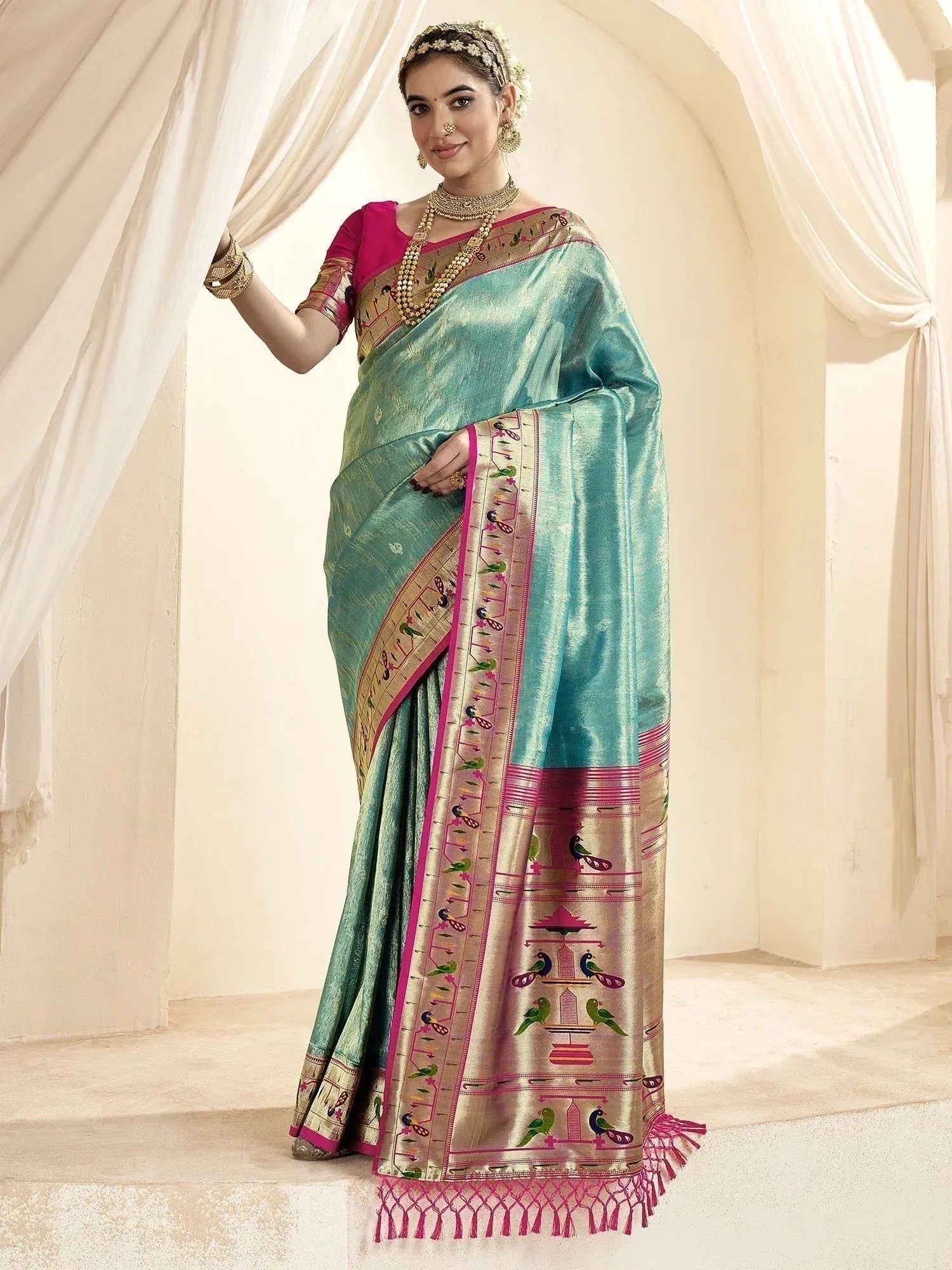Turquoise silk saree with pink and gold bird motifs, traditional Indian ethnic wear for women