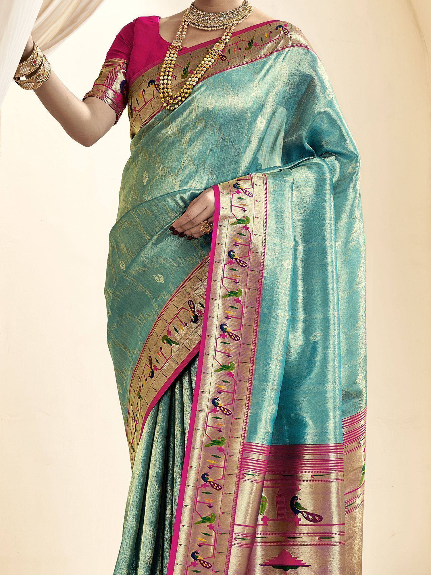 Turquoise silk saree with peacock embroidery, pink blouse, and gold jewelry for ethnic wear