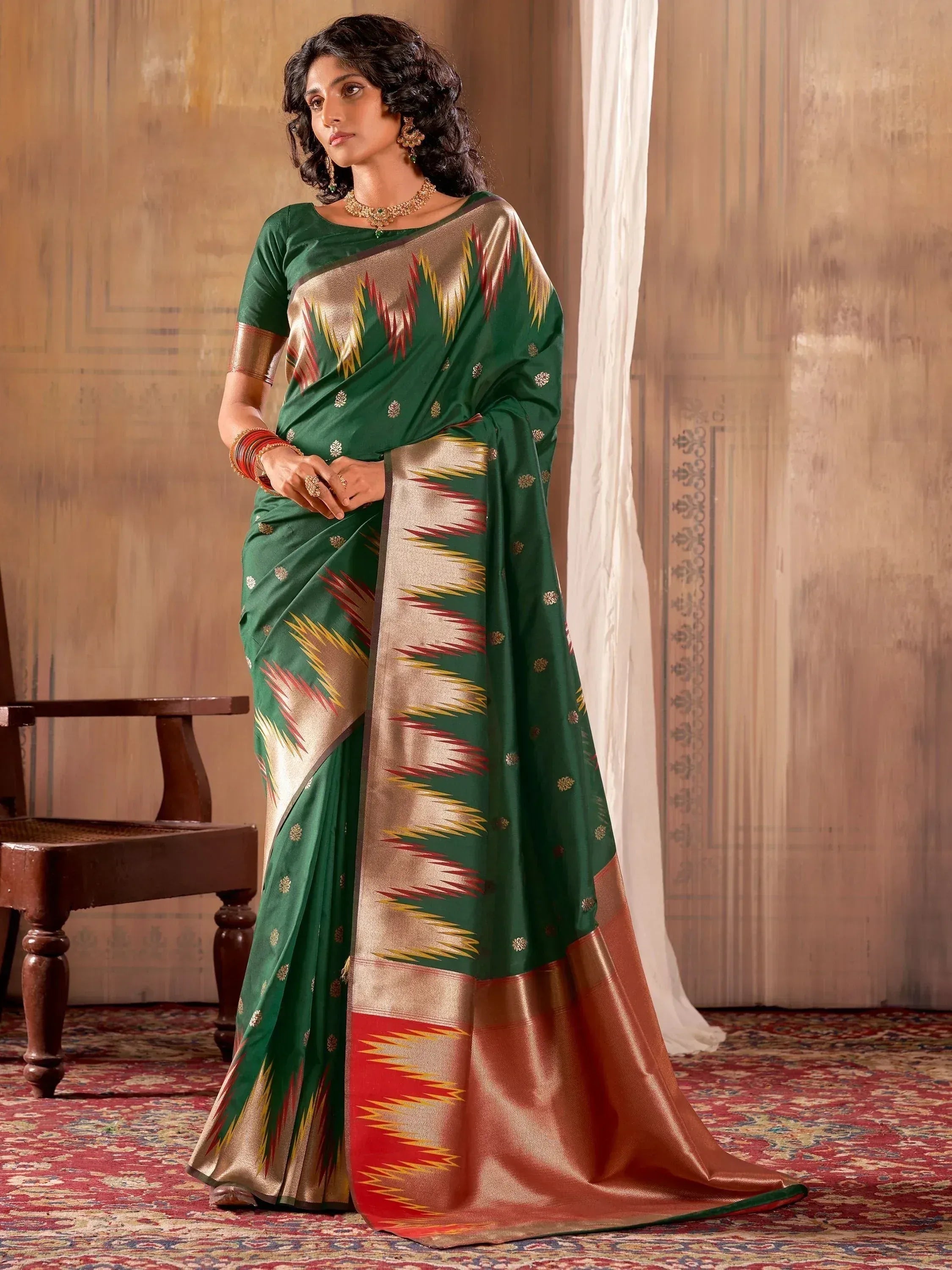 Green and gold ethnic saree with ikat pattern, perfect for Indian occasions and festive wear.