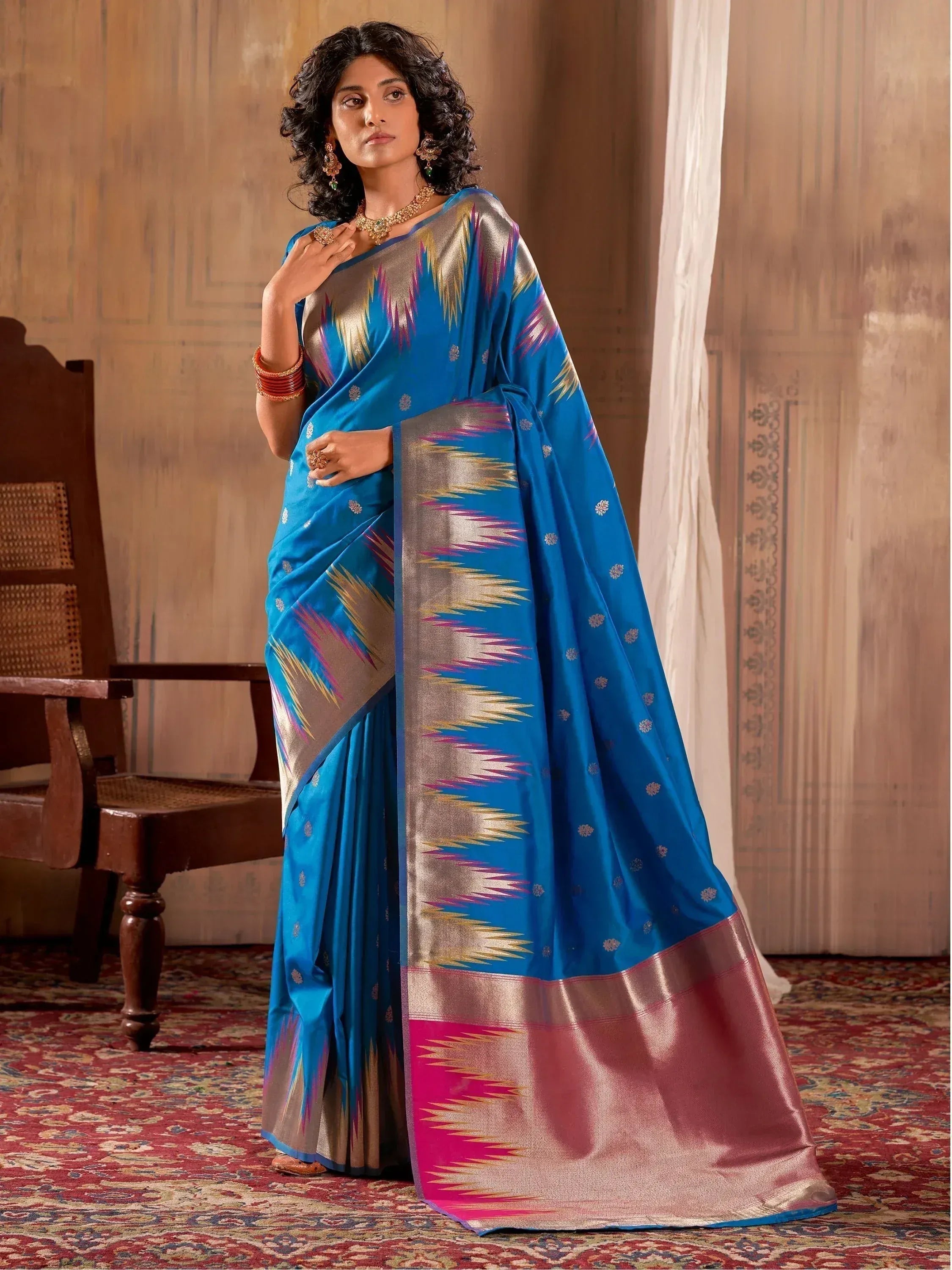 Blue designer saree with ikat pattern and gold border, perfect for ethnic occasions