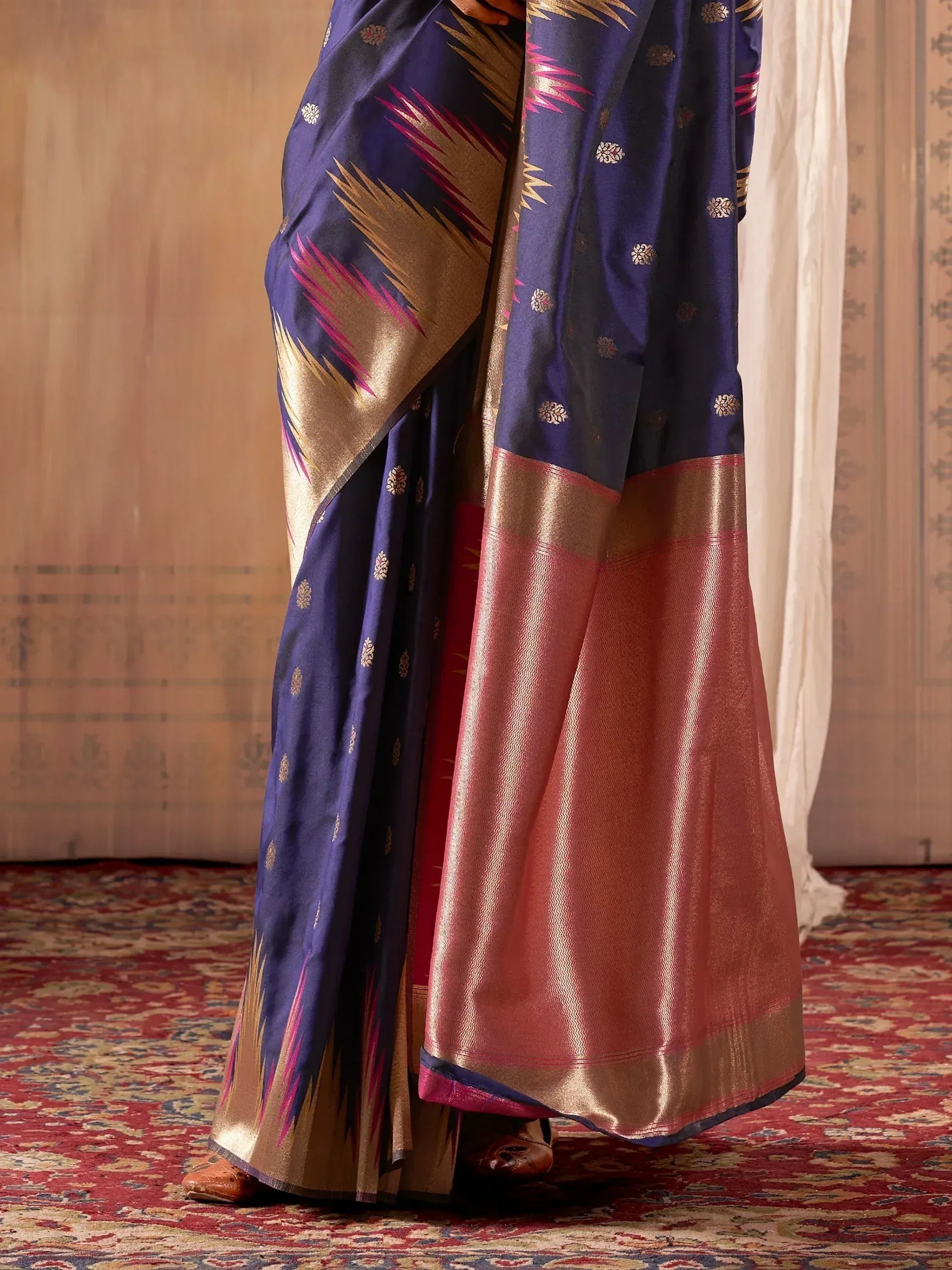 Navy blue silk saree with gold and pink ikat border, perfect for Indian ethnic wear occasions