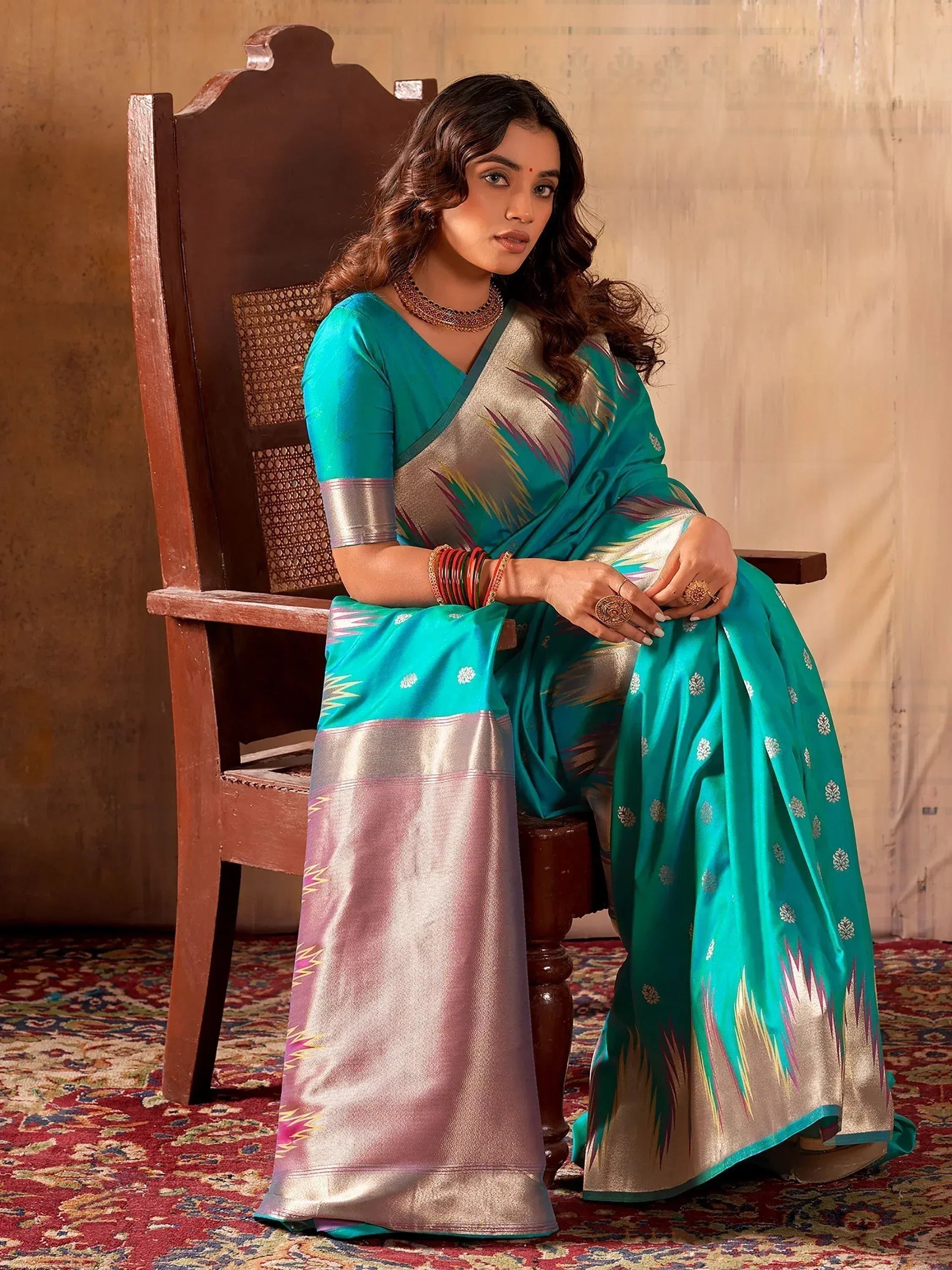 Teal and silver designer saree with intricate ikat patterns, perfect for ethnic occasions.