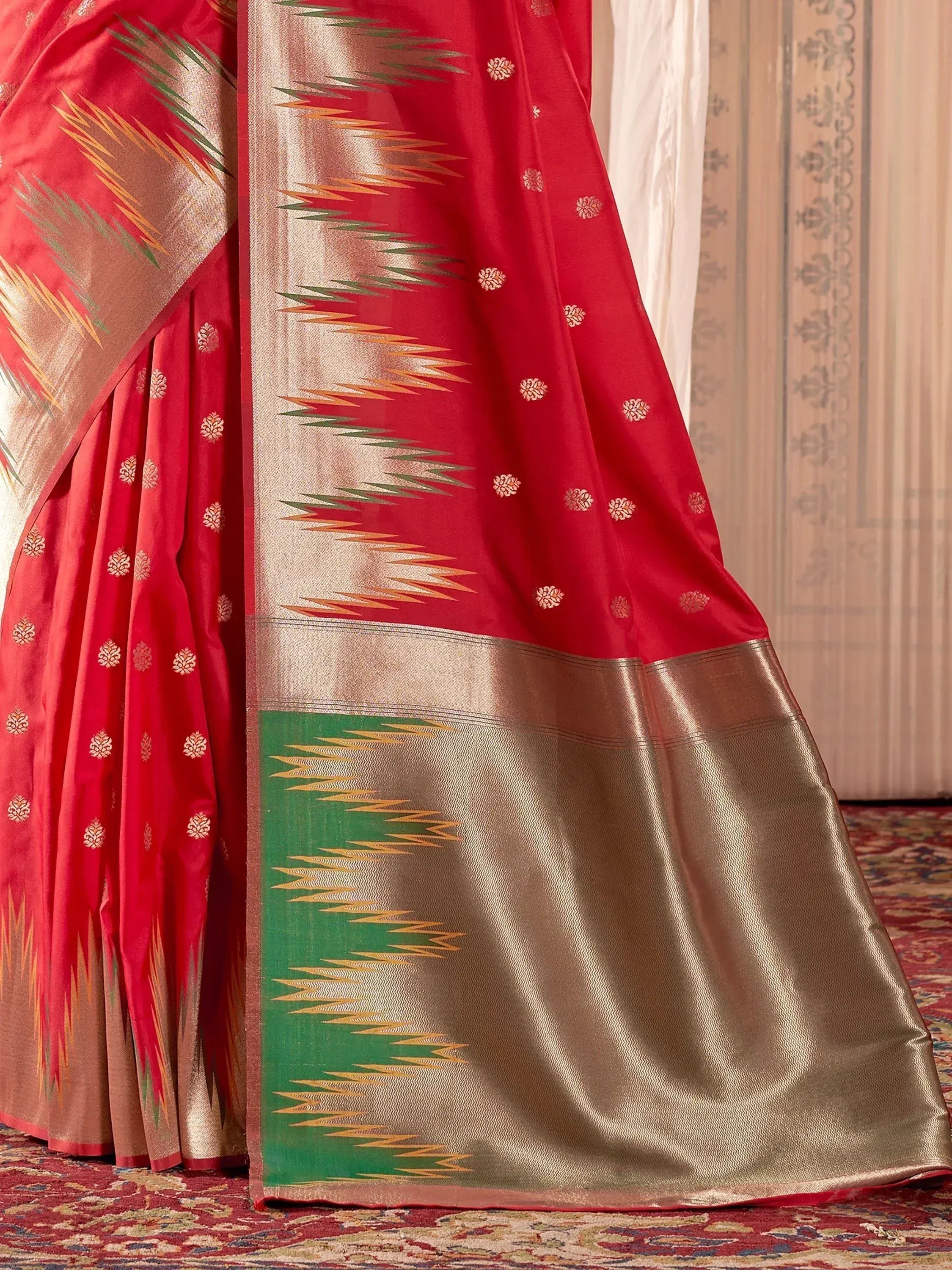 Red ethnic saree with gold and green ikat border, traditional Indian designer wear