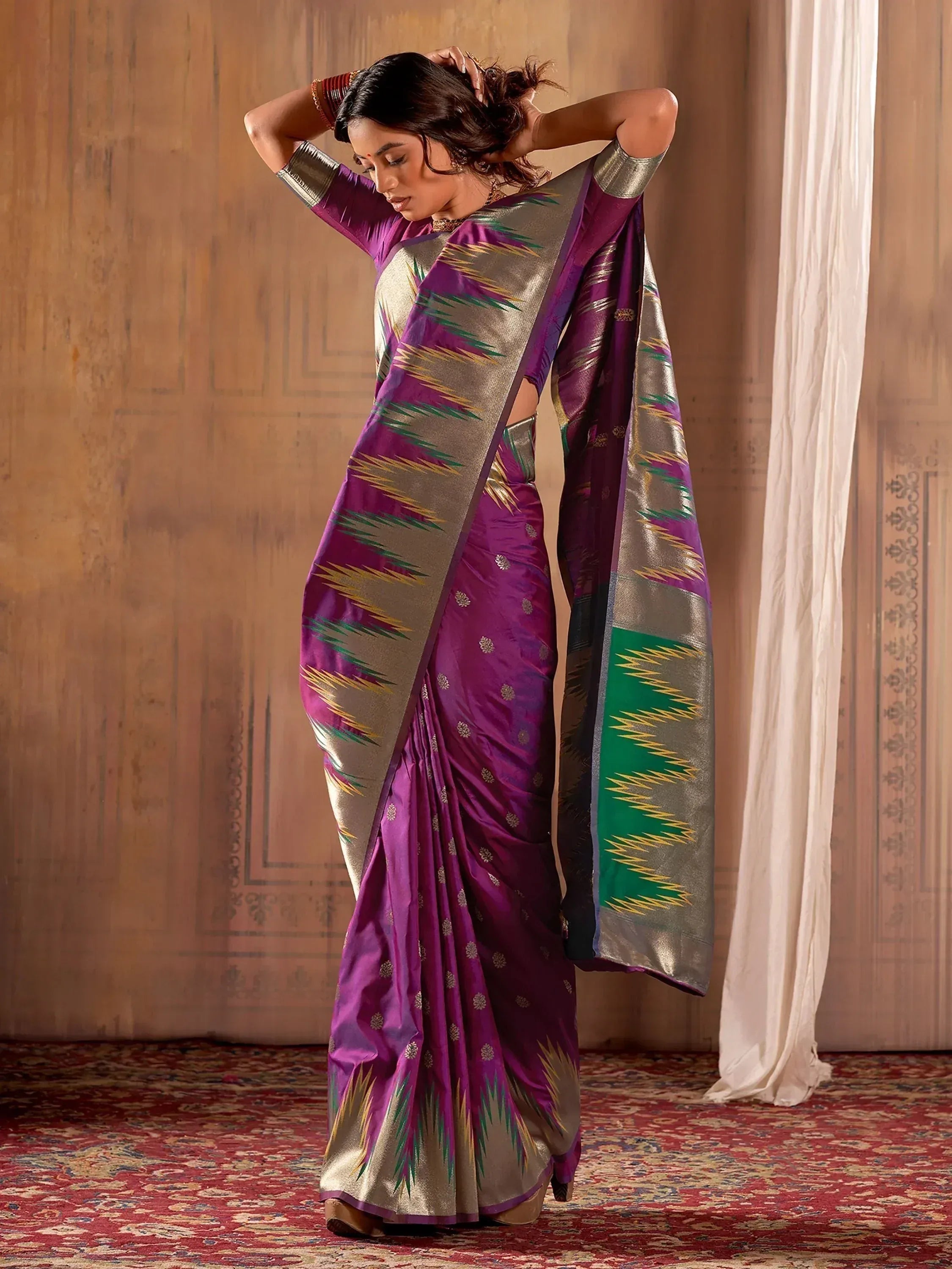 Purple and gold ethnic saree with intricate ikat patterns, perfect for Indian occasions and festive wear.