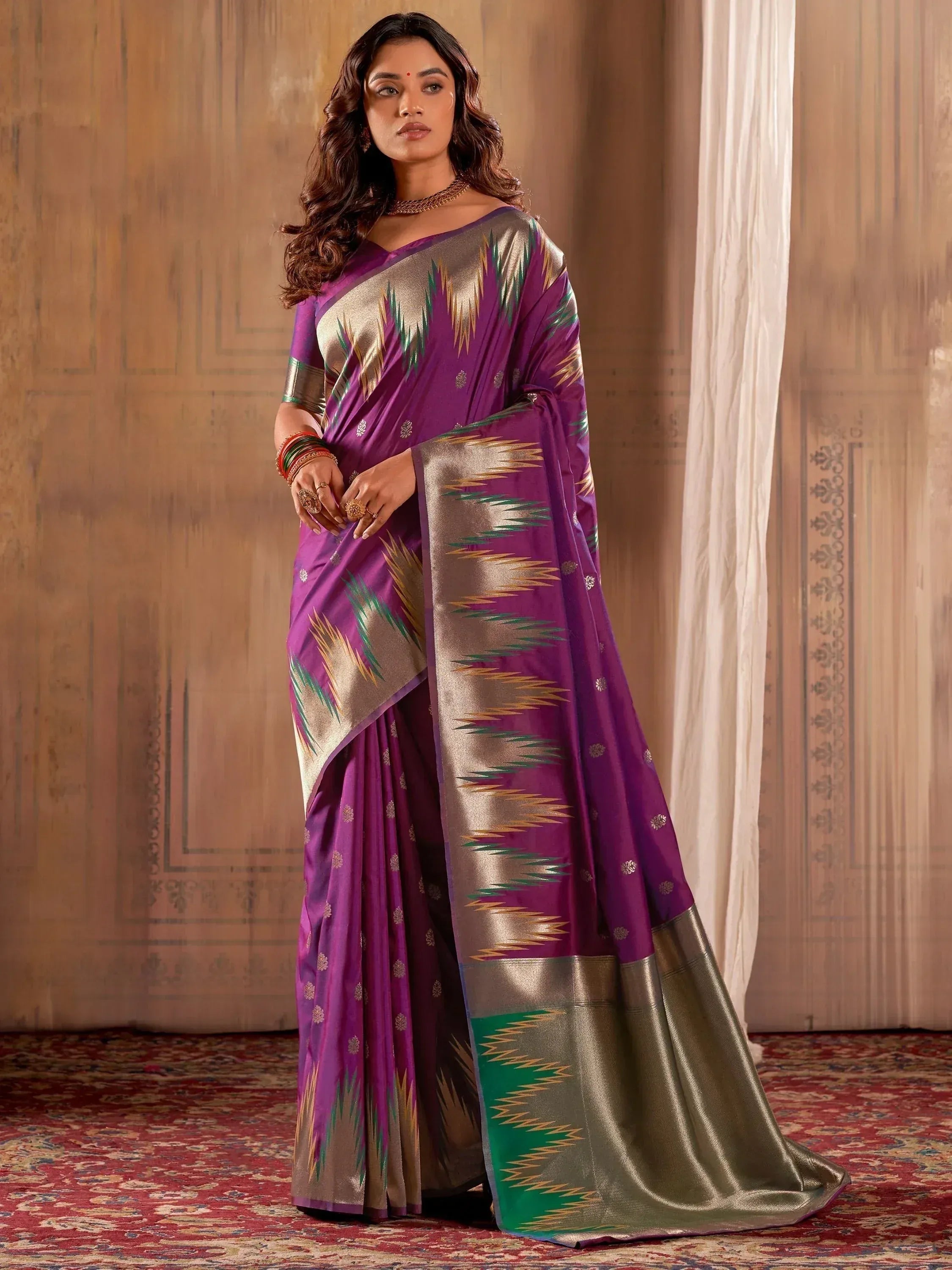 Purple and gold ethnic saree with ikat pattern, perfect for Indian occasions and festivals.