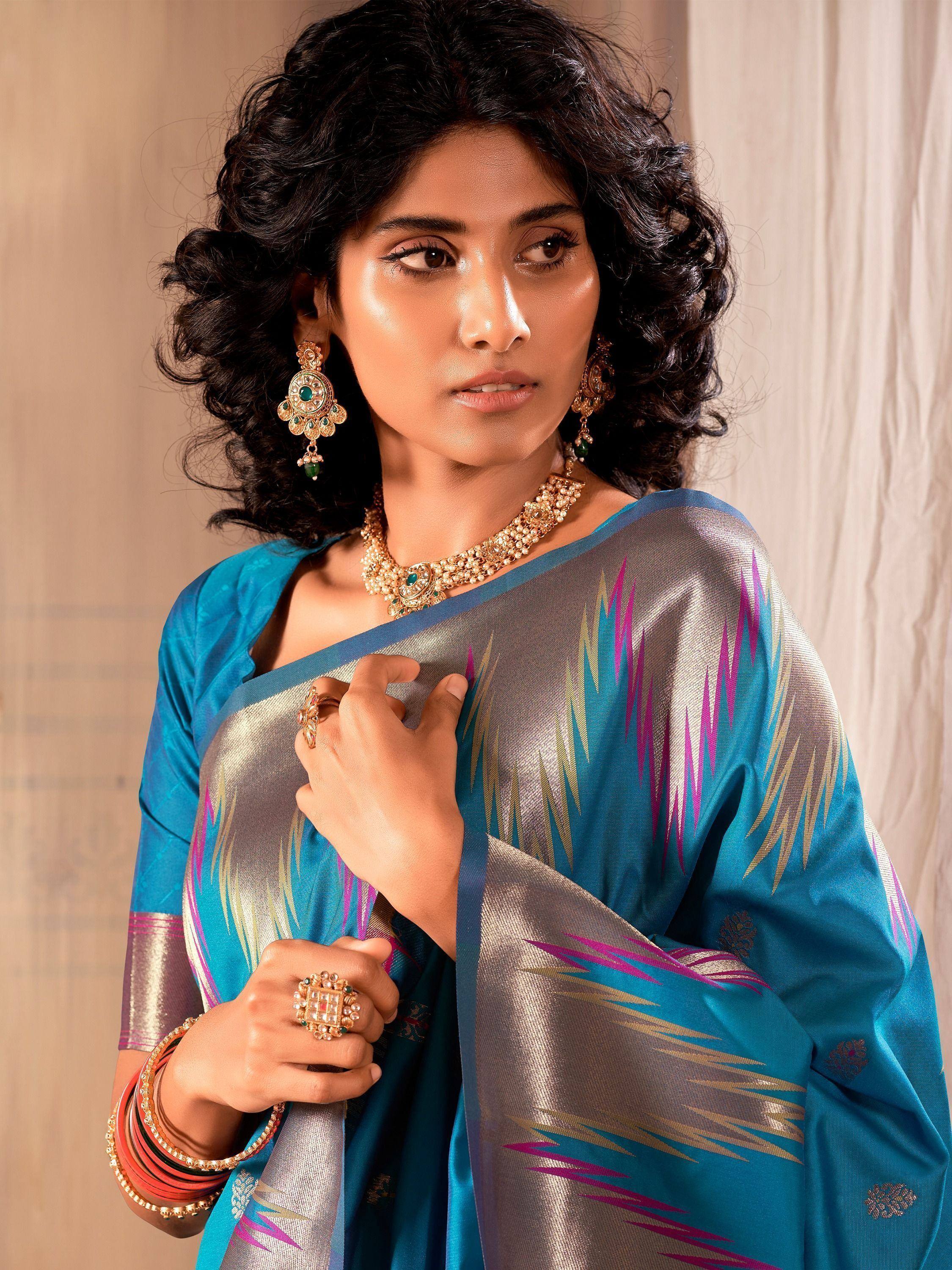Woman in blue and silver ikat saree with gold jewelry, Indian ethnic wear