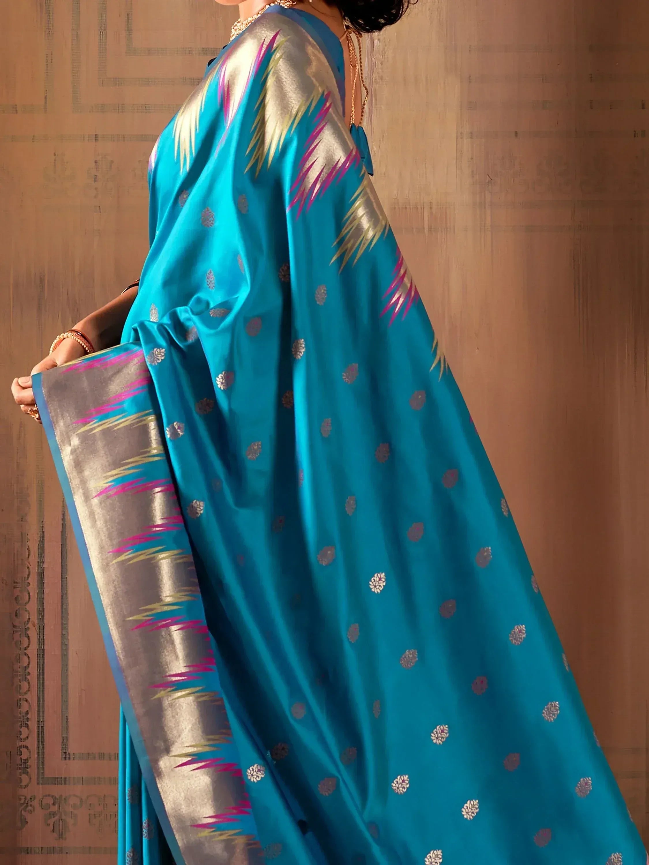 Turquoise silk saree with gold and pink ikat border, perfect for Indian ethnic wear occasions