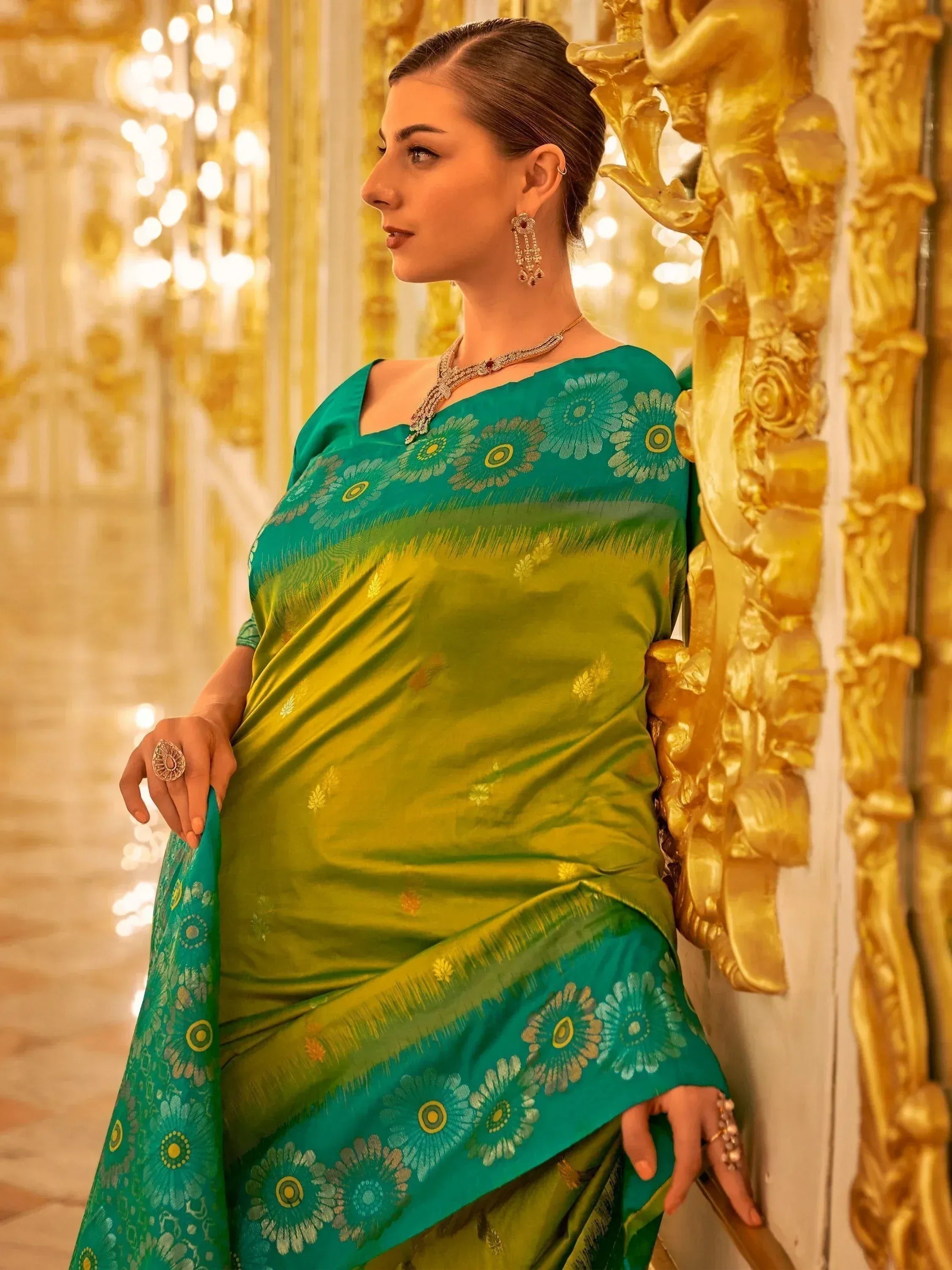 Elegant green and teal designer saree with floral border, perfect for Indian ethnic occasions
