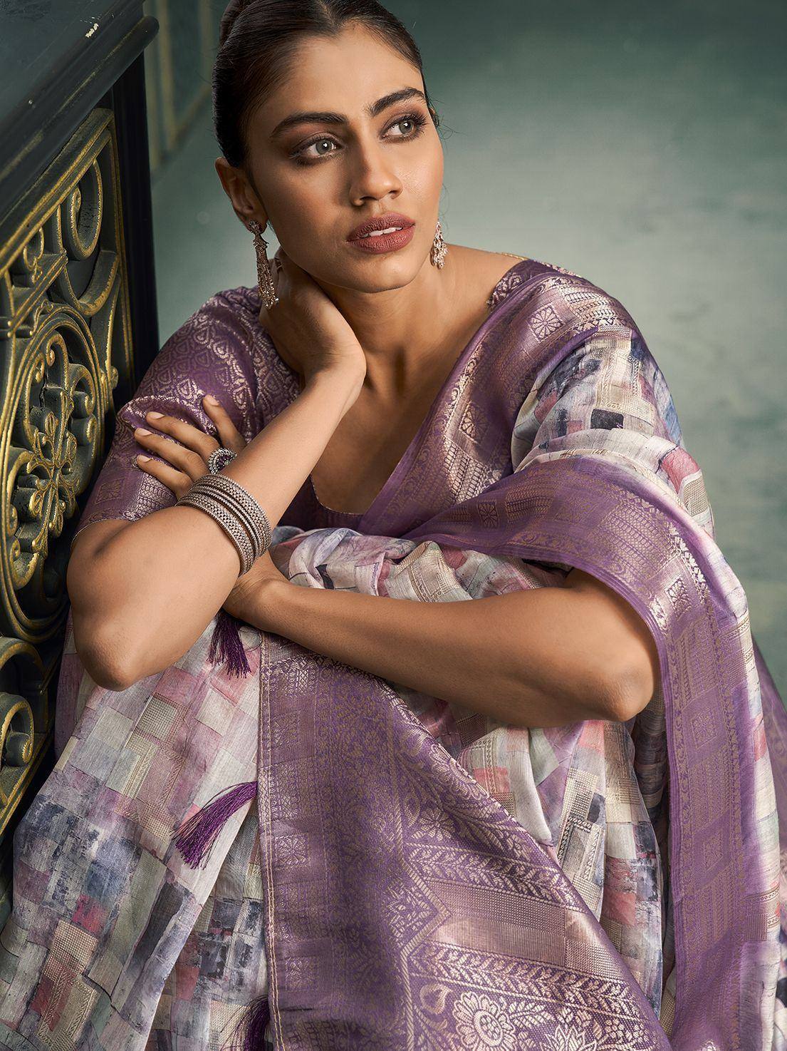 Purple printed saree with gold embroidery, styled with ethnic jewelry for traditional Indian wear