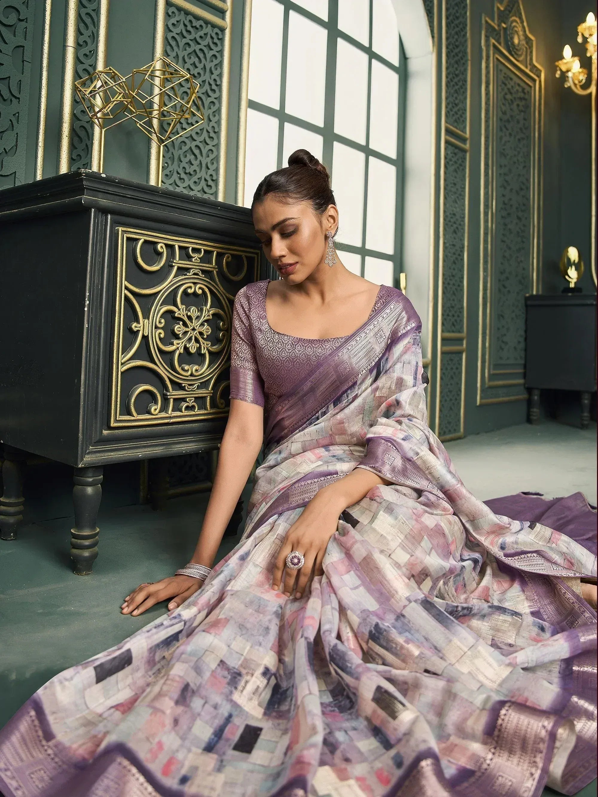 Woman in elegant purple printed saree with gold border, styled for Indian ethnic wear occasions.