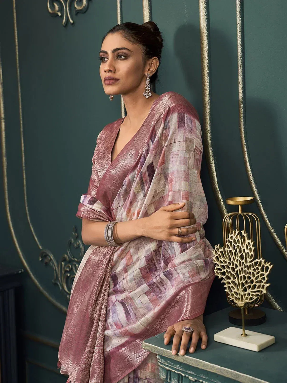 Woman in elegant pink printed saree with gold embroidery, styled for Indian ethnic wear occasions