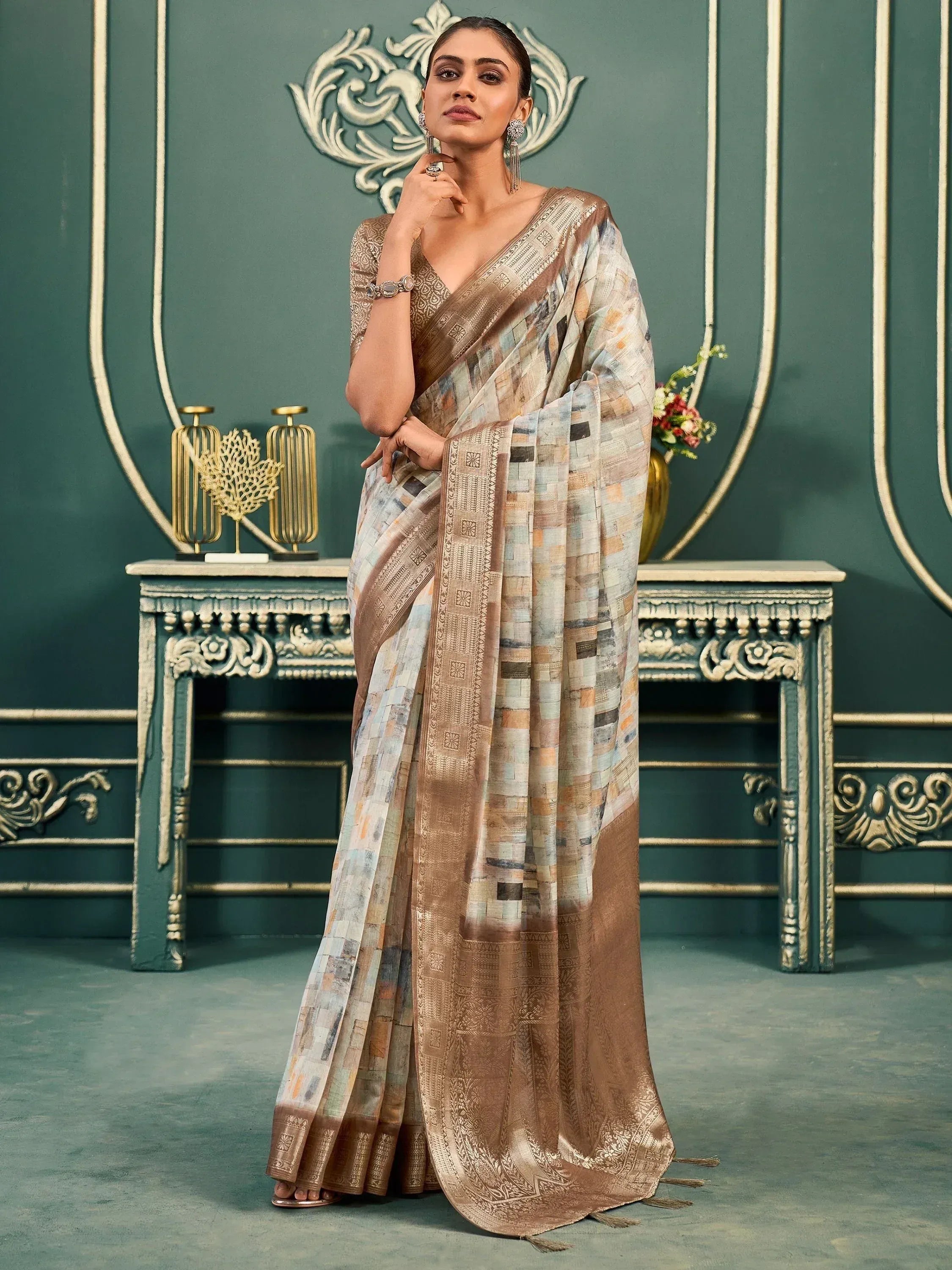 Elegant woman in designer saree with patchwork print and golden border, perfect for ethnic occasions