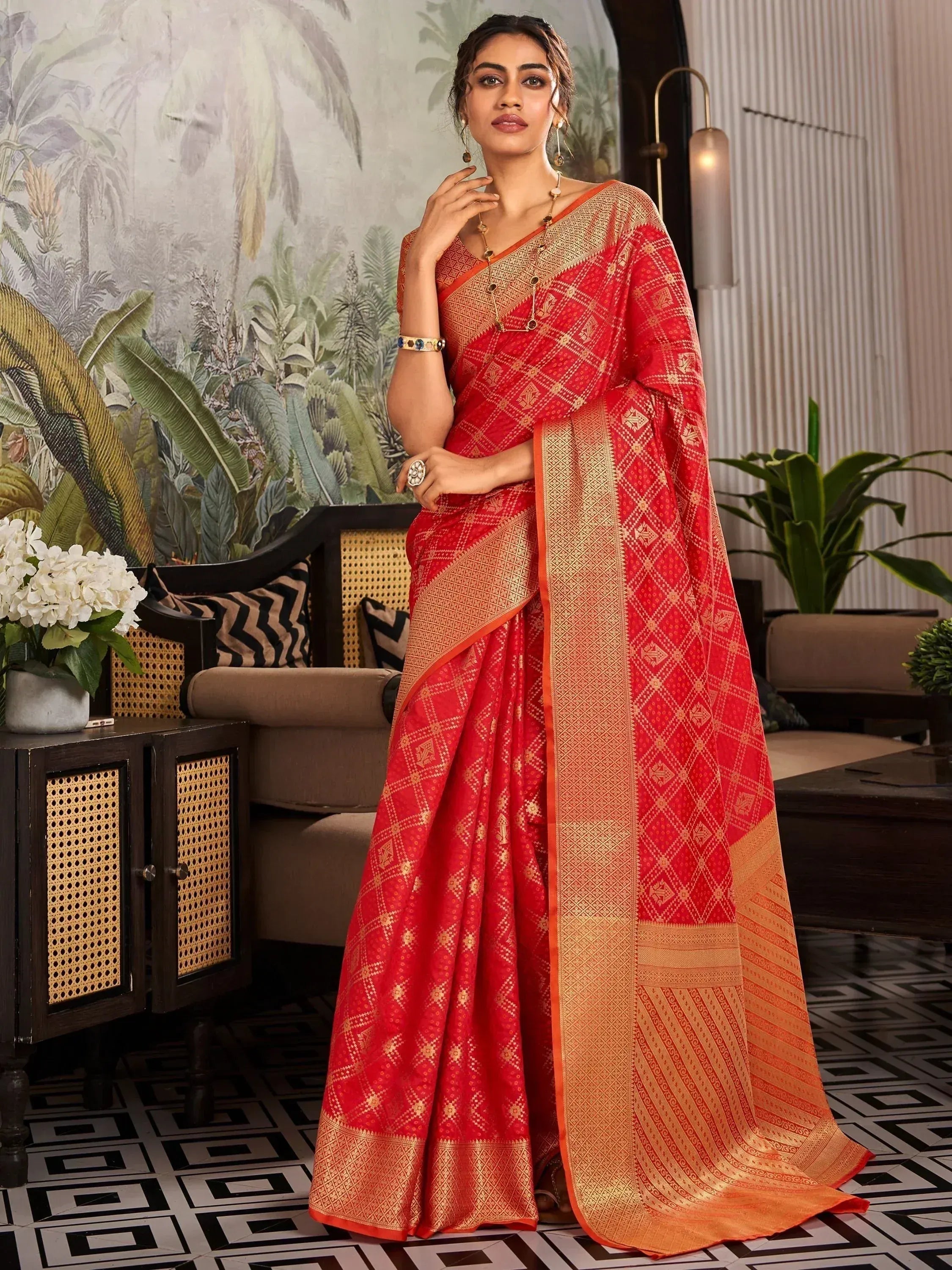 Red and gold designer saree with intricate patterns, perfect for ethnic occasions