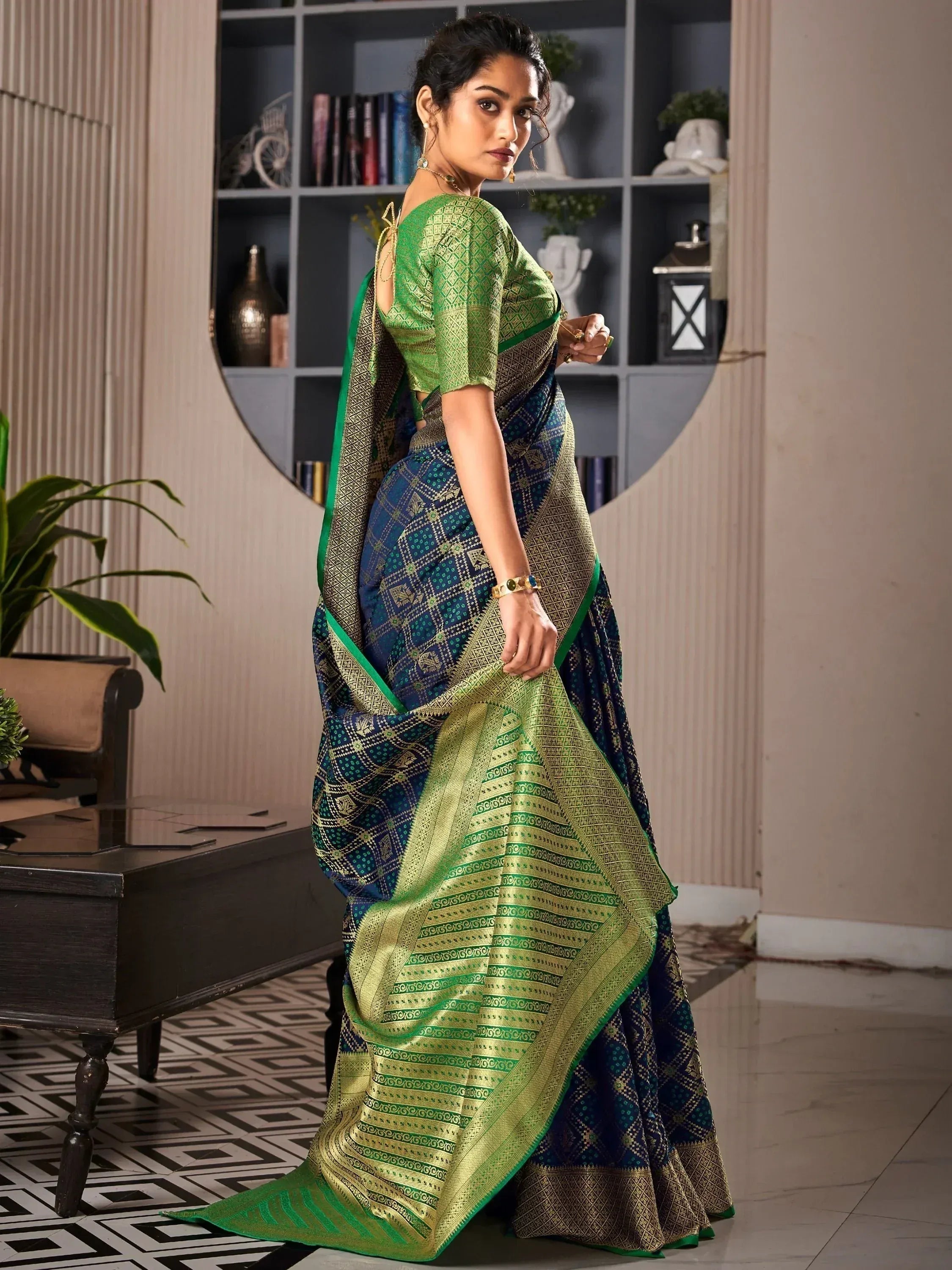 Woman in elegant green and blue ethnic saree with intricate gold patterns, perfect for Indian occasions