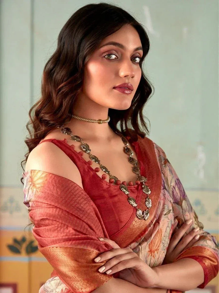 Woman in red floral saree with off-shoulder blouse, ethnic jewelry, and wavy hair