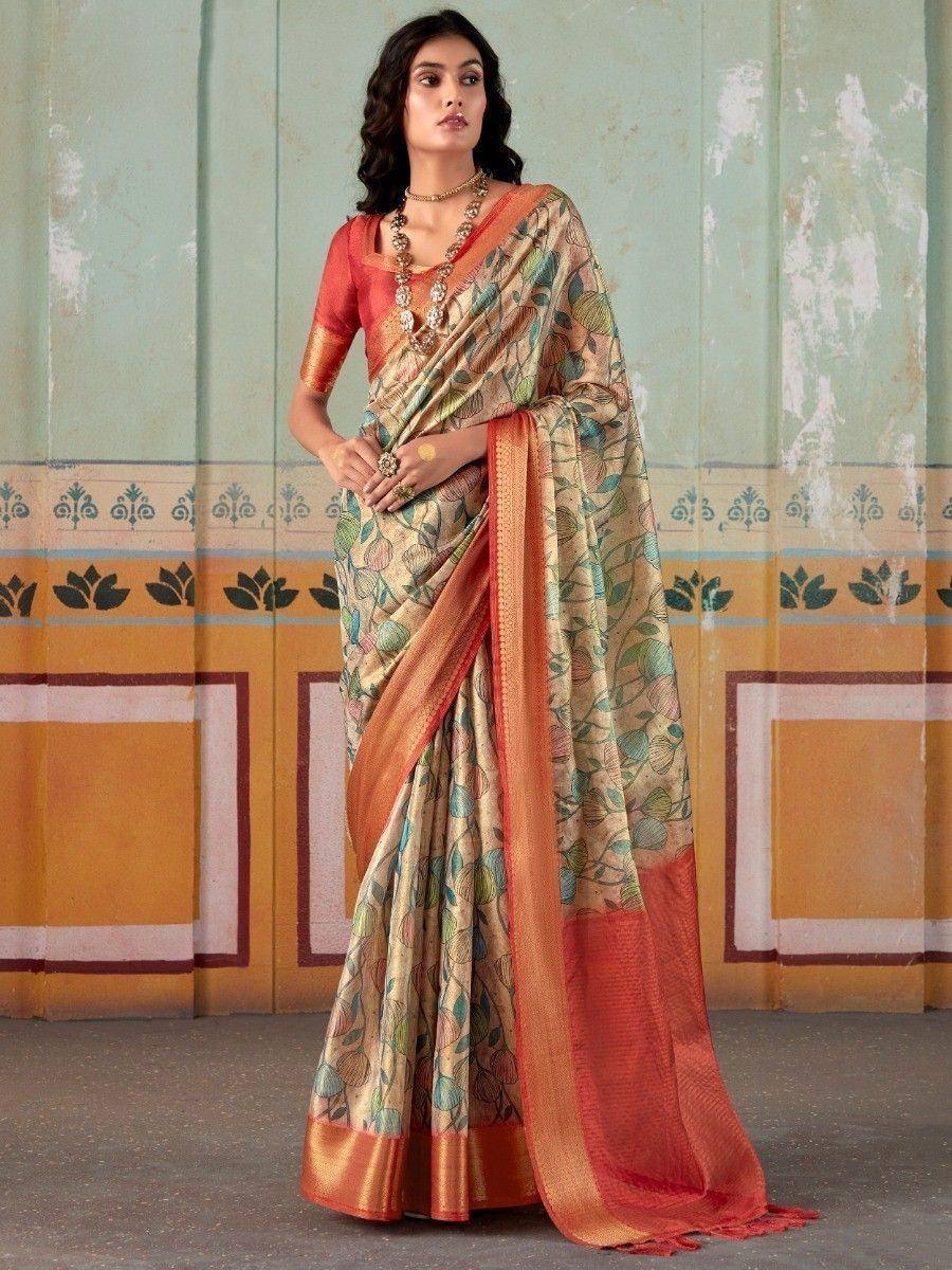 Woman in elegant floral print saree with orange border, traditional Indian ethnic wear