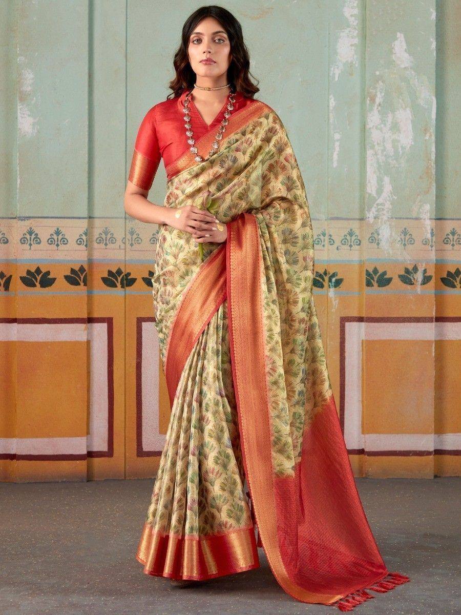Woman in floral print saree with red blouse and border, ethnic Indian wear