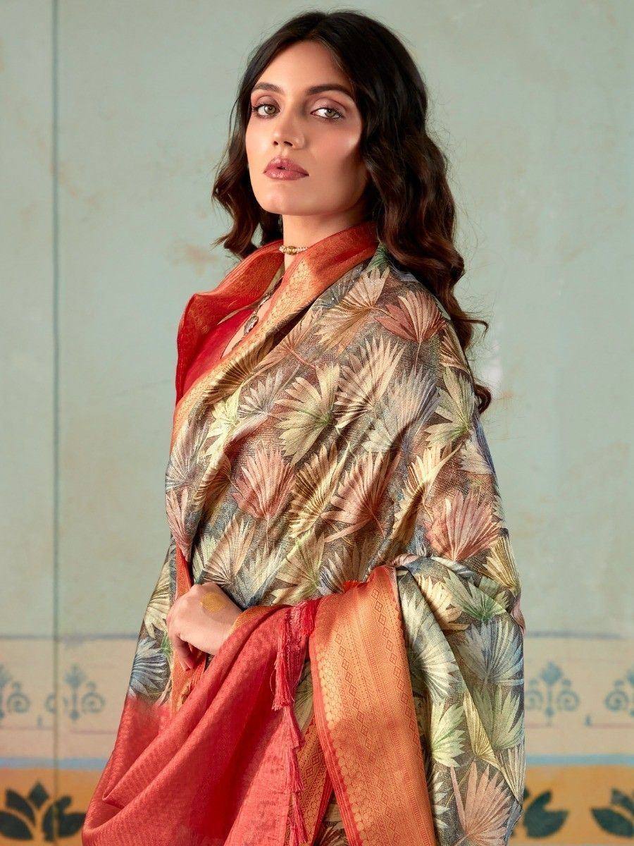Woman in printed ethnic saree with floral motifs and red border, styled for traditional occasions