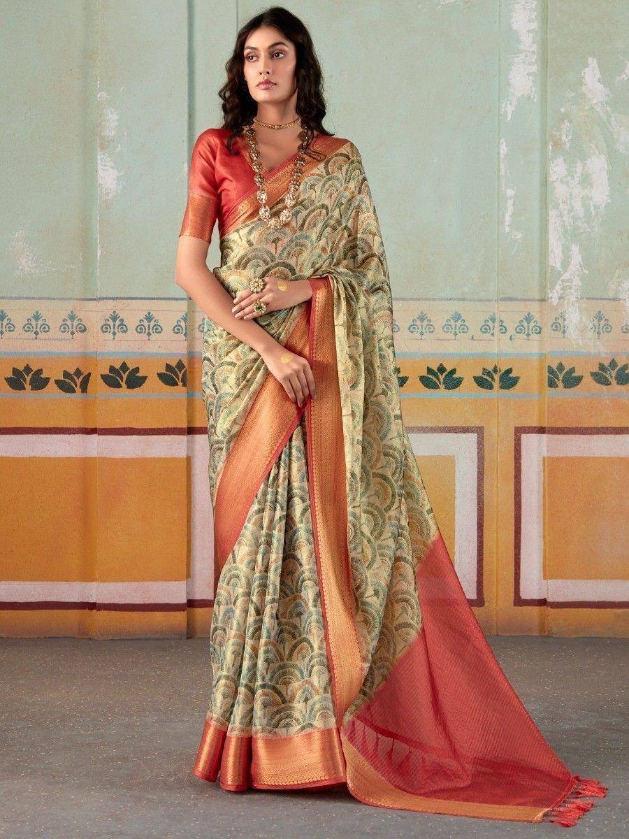 Elegant Indian saree with intricate patterns and vibrant orange border, styled with traditional jewelry.