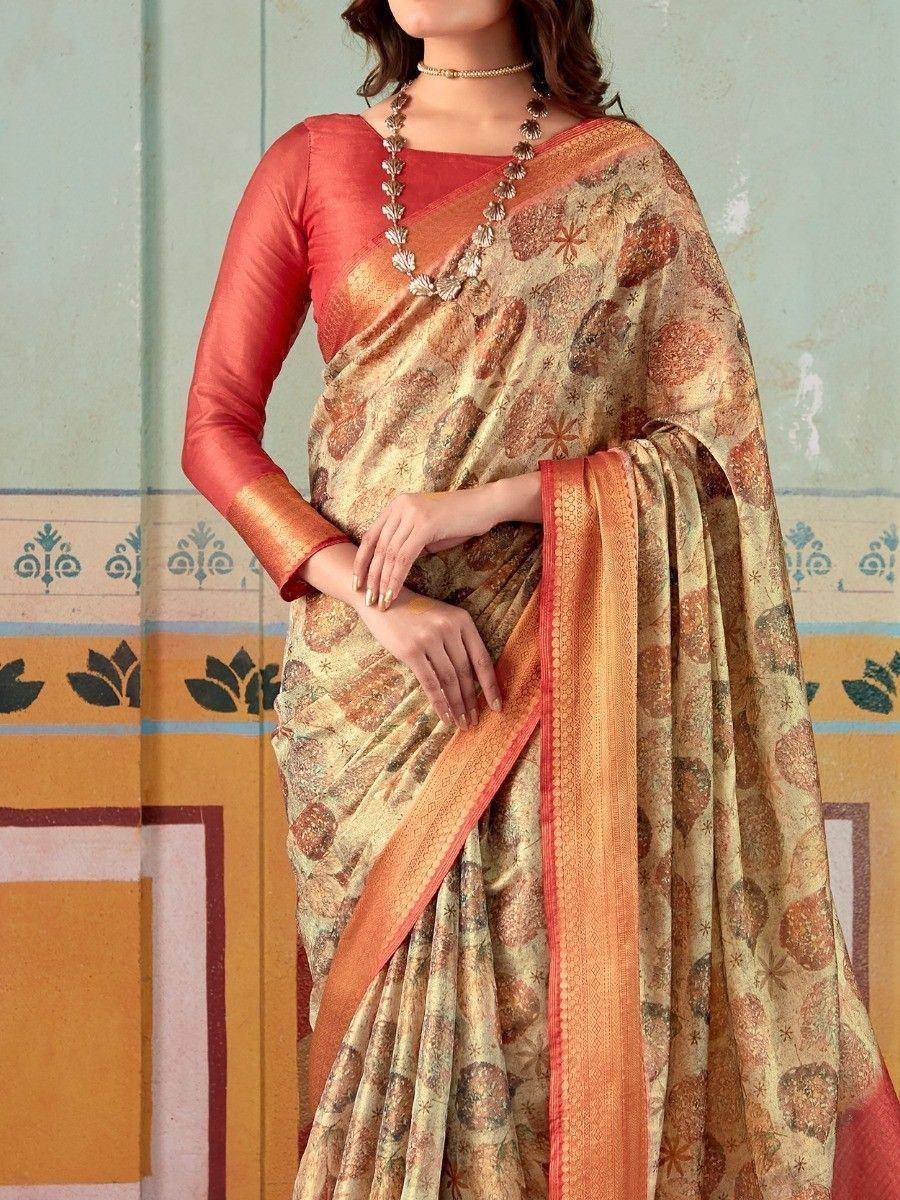Elegant Indian saree with floral print and orange border, paired with a matching blouse.