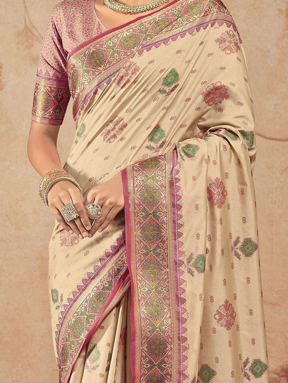 Beige floral saree with pink and green border, paired with matching blouse, ideal for Indian ethnic wear.