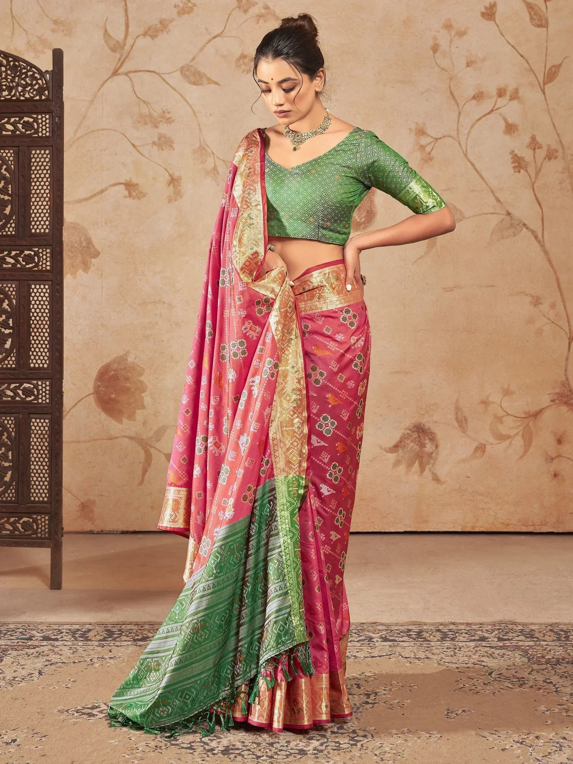 Pink and green designer saree with gold border, paired with matching blouse, ideal for ethnic occasions
