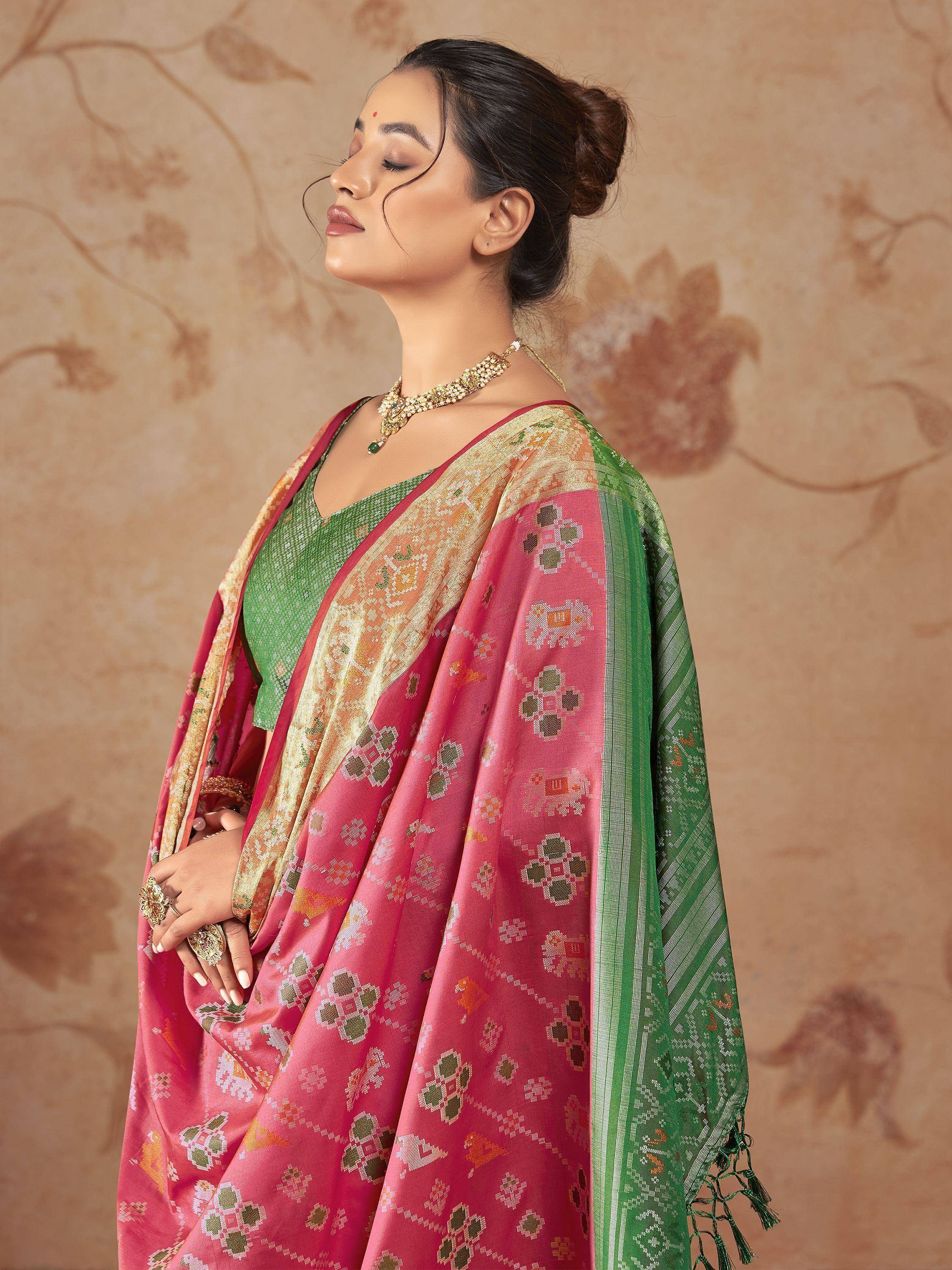 Pink and green designer saree with intricate patterns and gold border, perfect for ethnic occasions