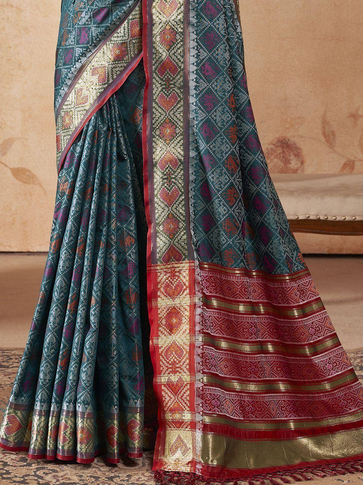 Teal designer saree with red gold border, intricate woven patterns, ethnic Indian wear