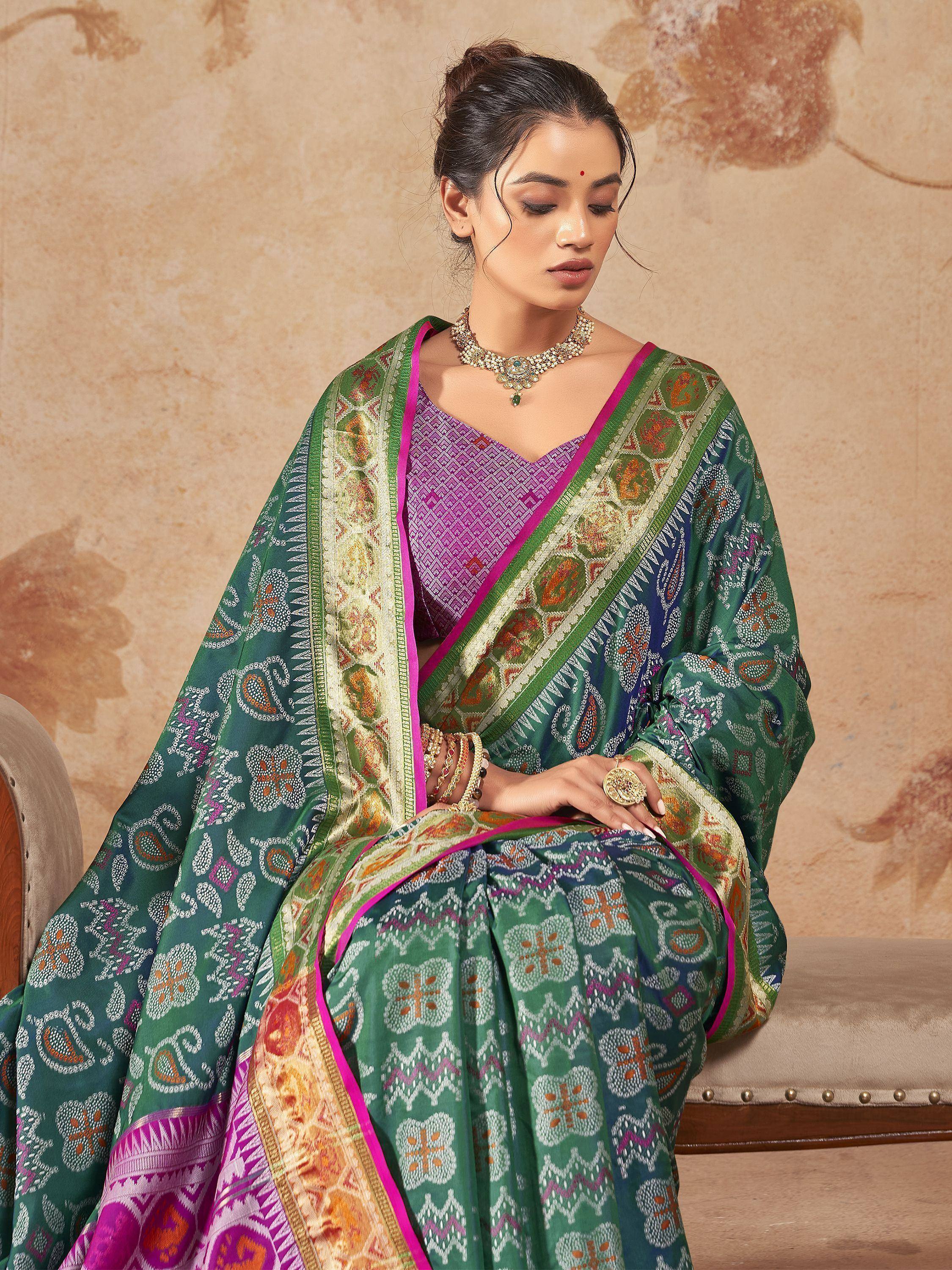 Woman in green printed saree with pink border, ethnic Indian wear, traditional jewelry, designer saree
