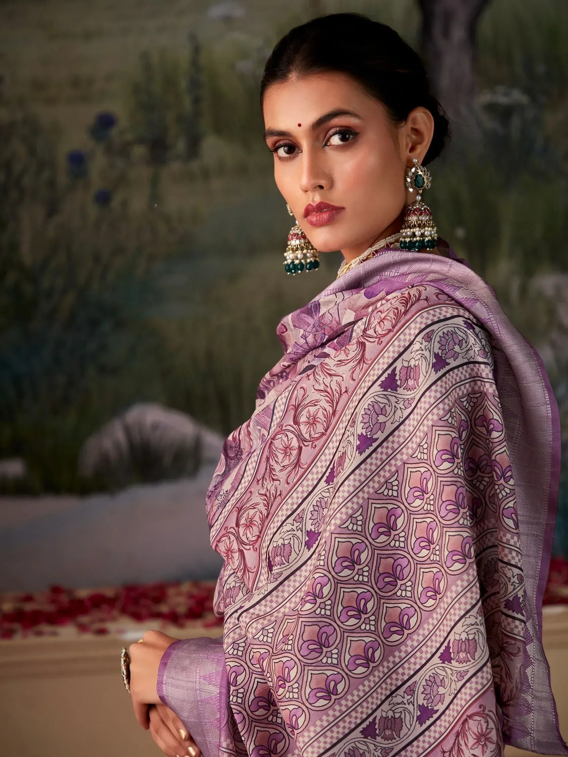 Woman in purple floral ethnic saree with traditional jewelry, perfect for Indian occasions